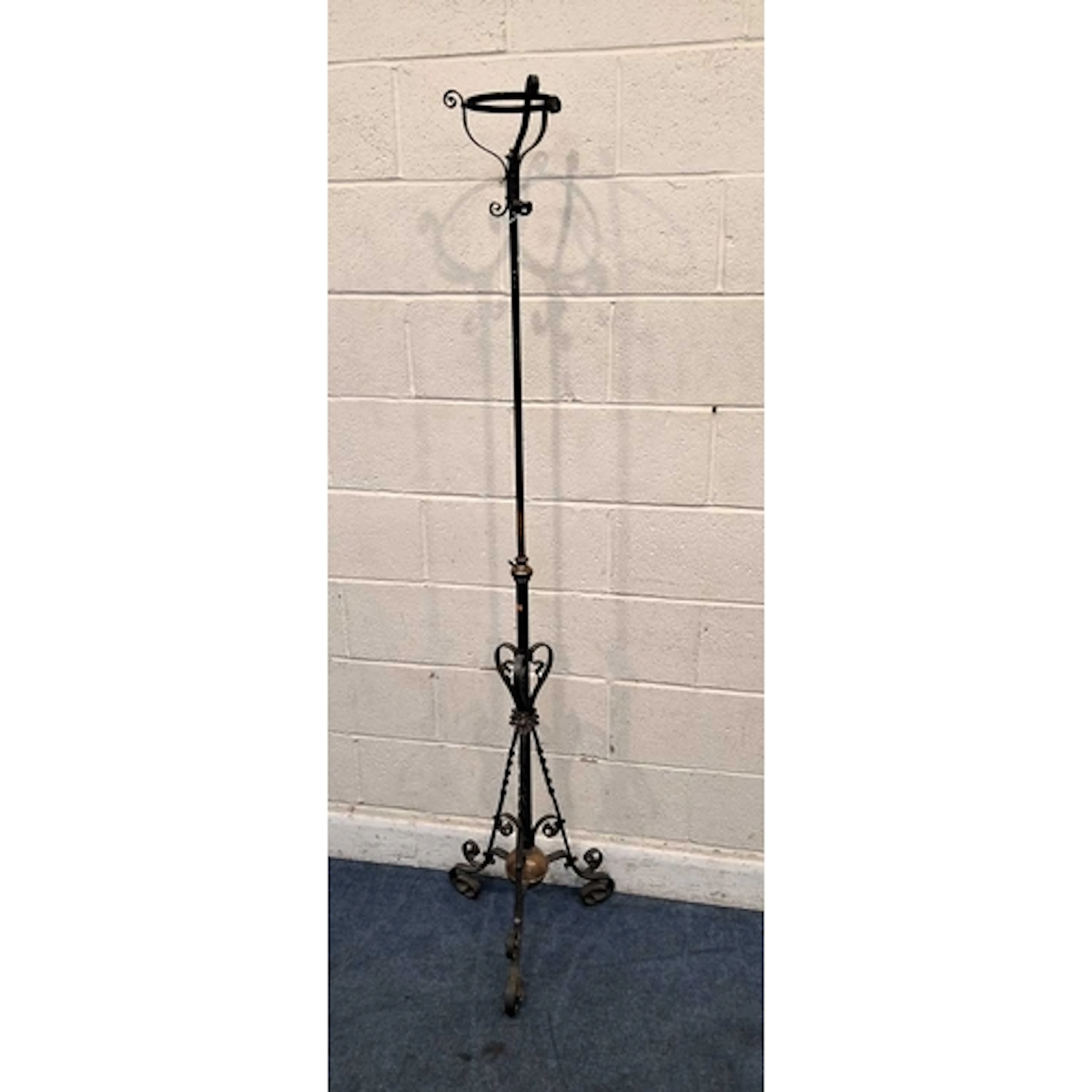 A WROUGHT IRON TELESCOPIC OIL LAMP STAND, with a cradle top,...