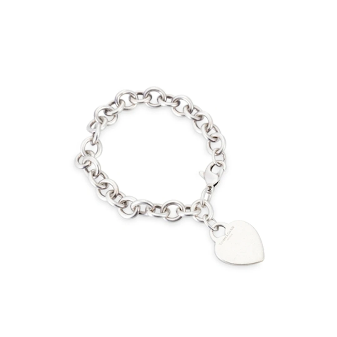 A SILVER TIFFANY BRACELET, with heart charm attached, 7.5"