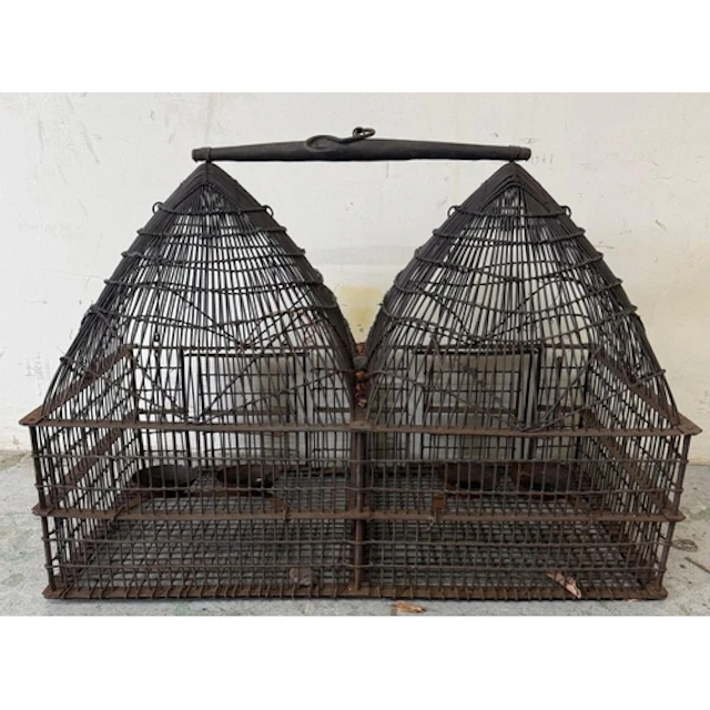 A vintage wire double-domed birdcage with central handle. He...