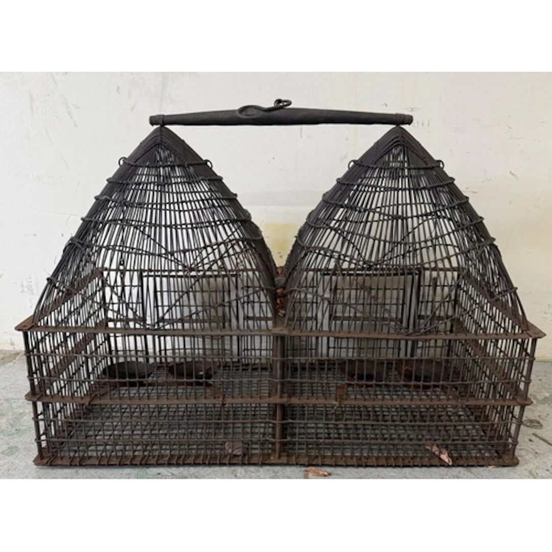 A vintage wire double-domed birdcage with central handle. He...