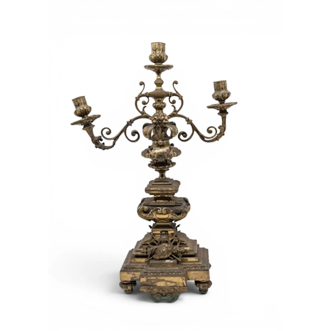 A GILT BRASS THREE BRANCH CANDELABRA decorated with a lion's...