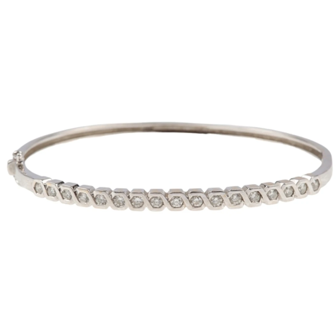 A diamond bangle, of hinged design, set to the front with a ...
