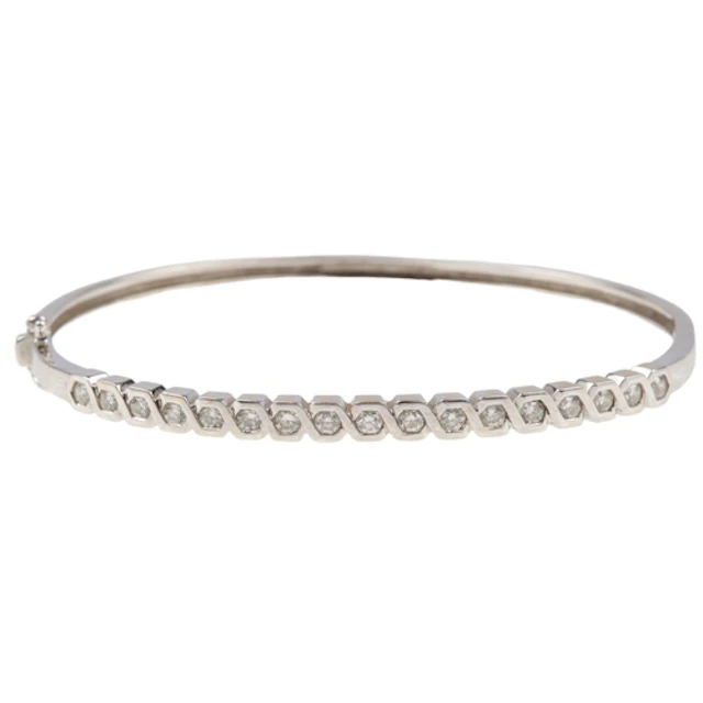 A diamond bangle, of hinged design, set to the front with a ...