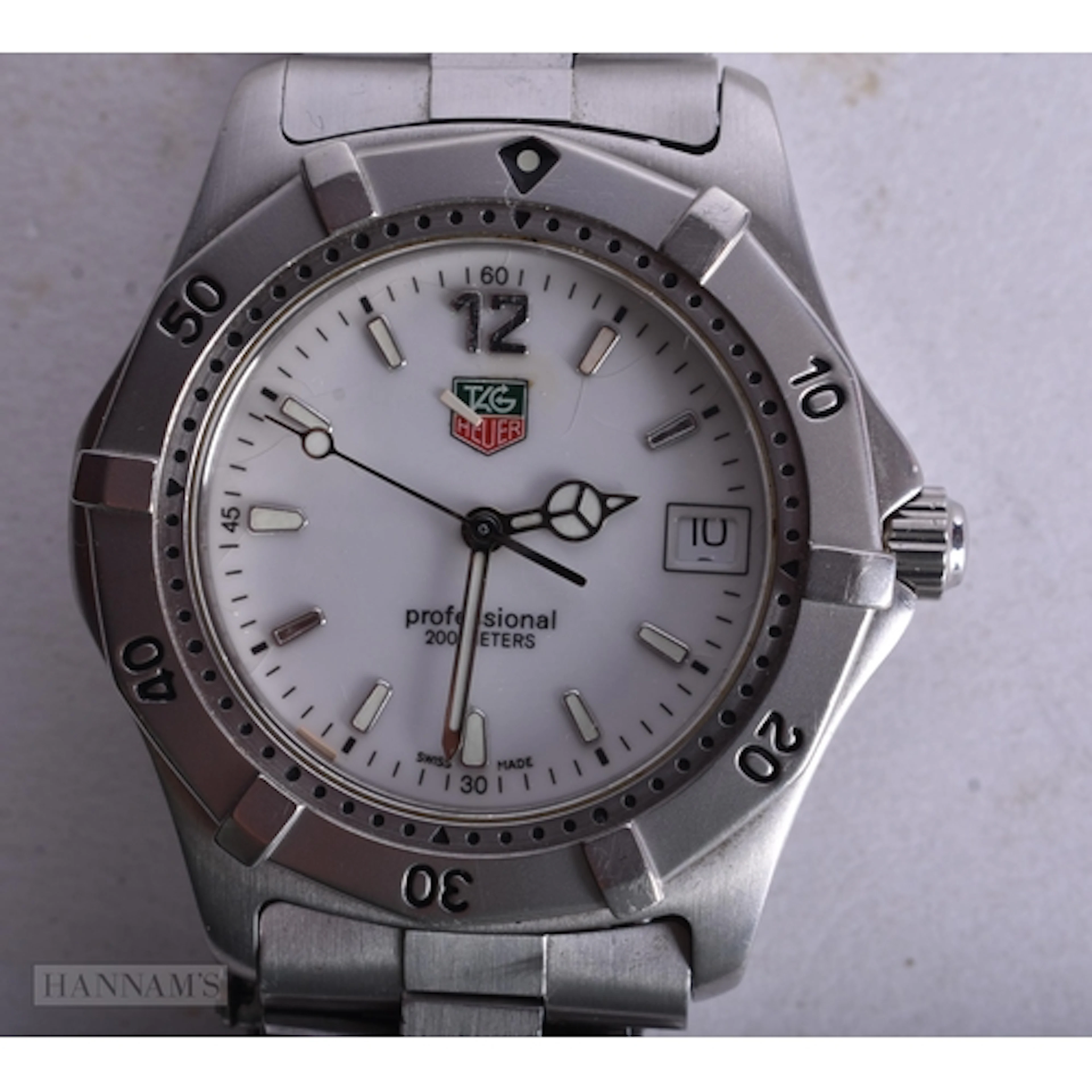 A TAG HEUER WRIST WATCH. Not running. 3.75 cm wide.