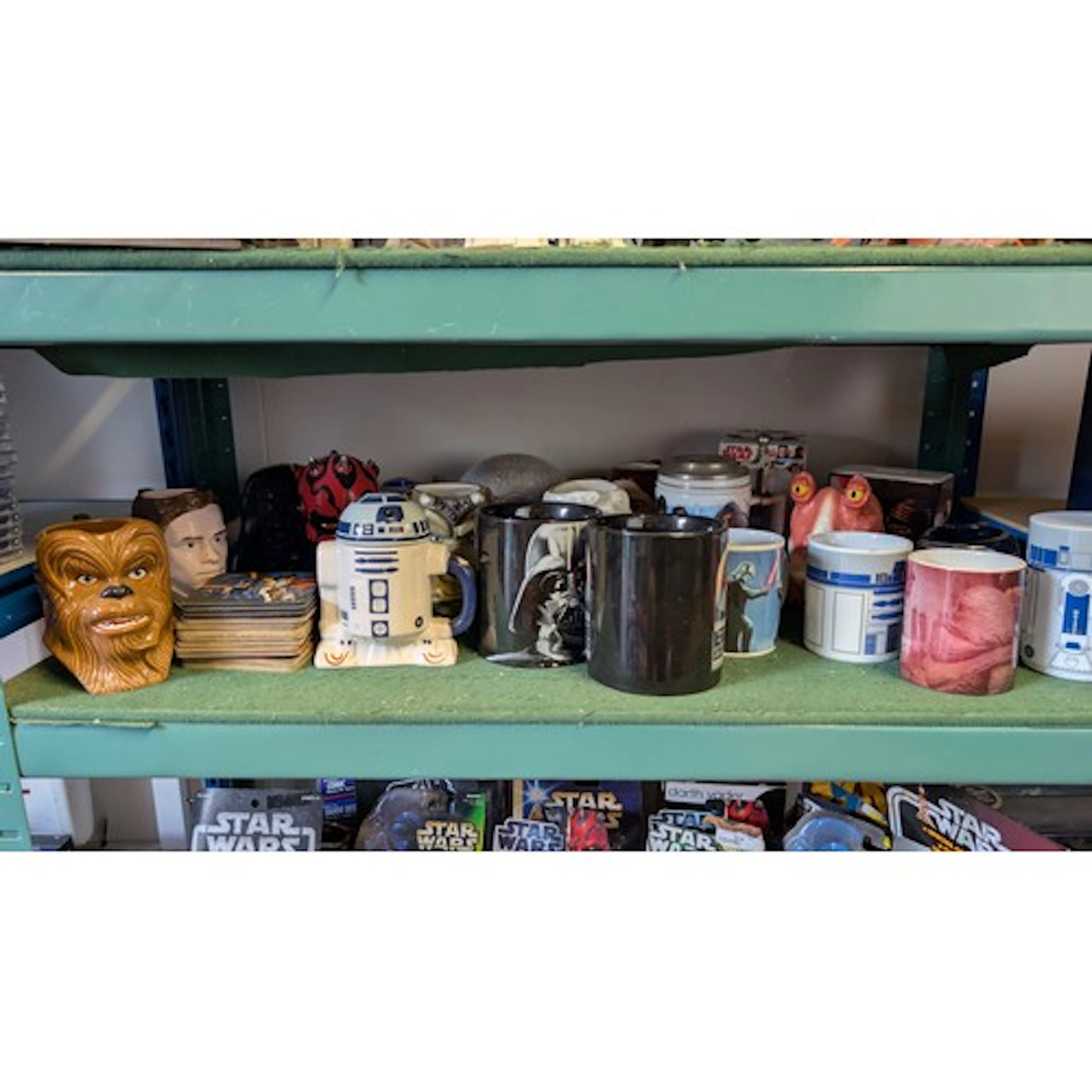 Shelf of mostly mugs relating to Star Wars inc. figure head ...
