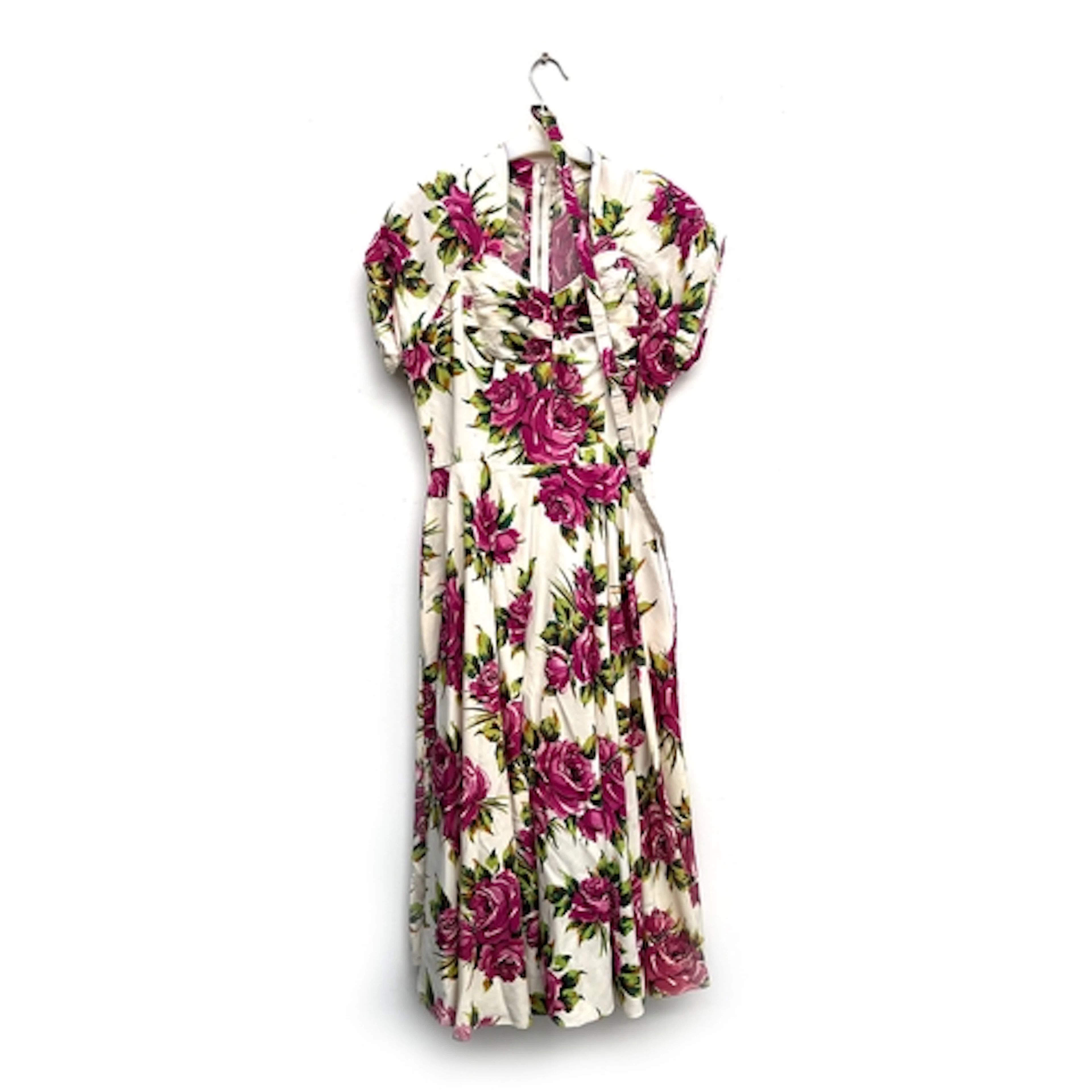 A vintage short sleeved dress in a cream and floral print, s...
