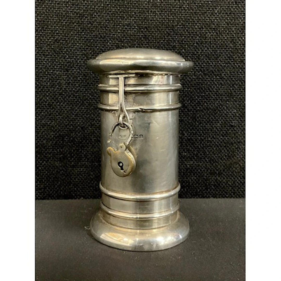 An Edwardian silver novelty coin bank, as a post box, cylind...