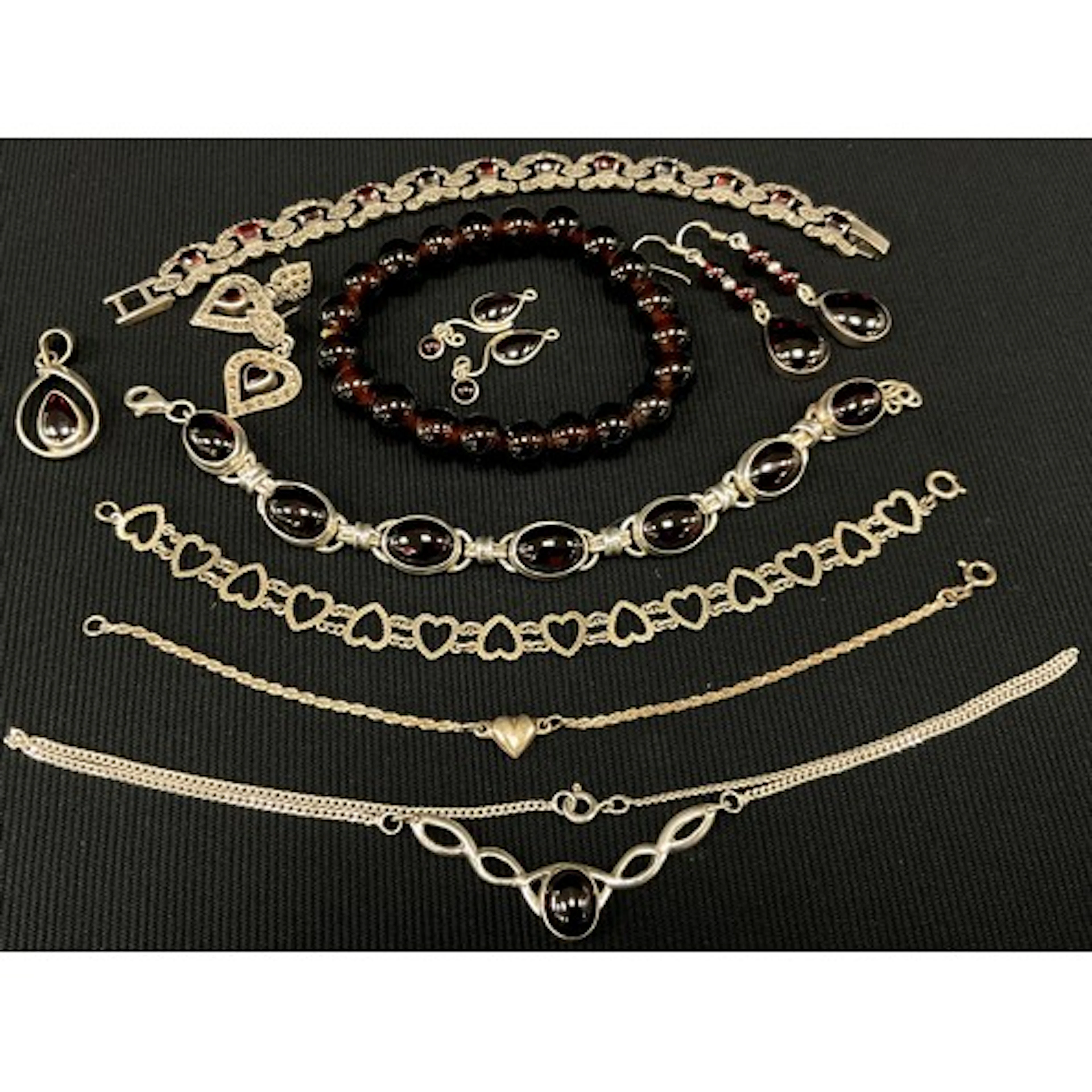 A silver metal and deep red garnet effect glass cabochon bra...