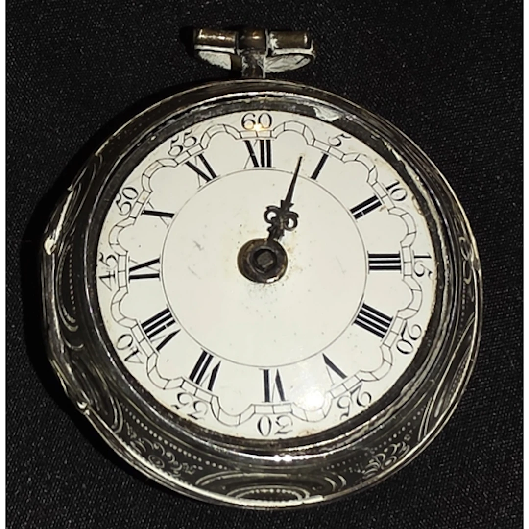 A 19th century pocket watch with embossed white metal case