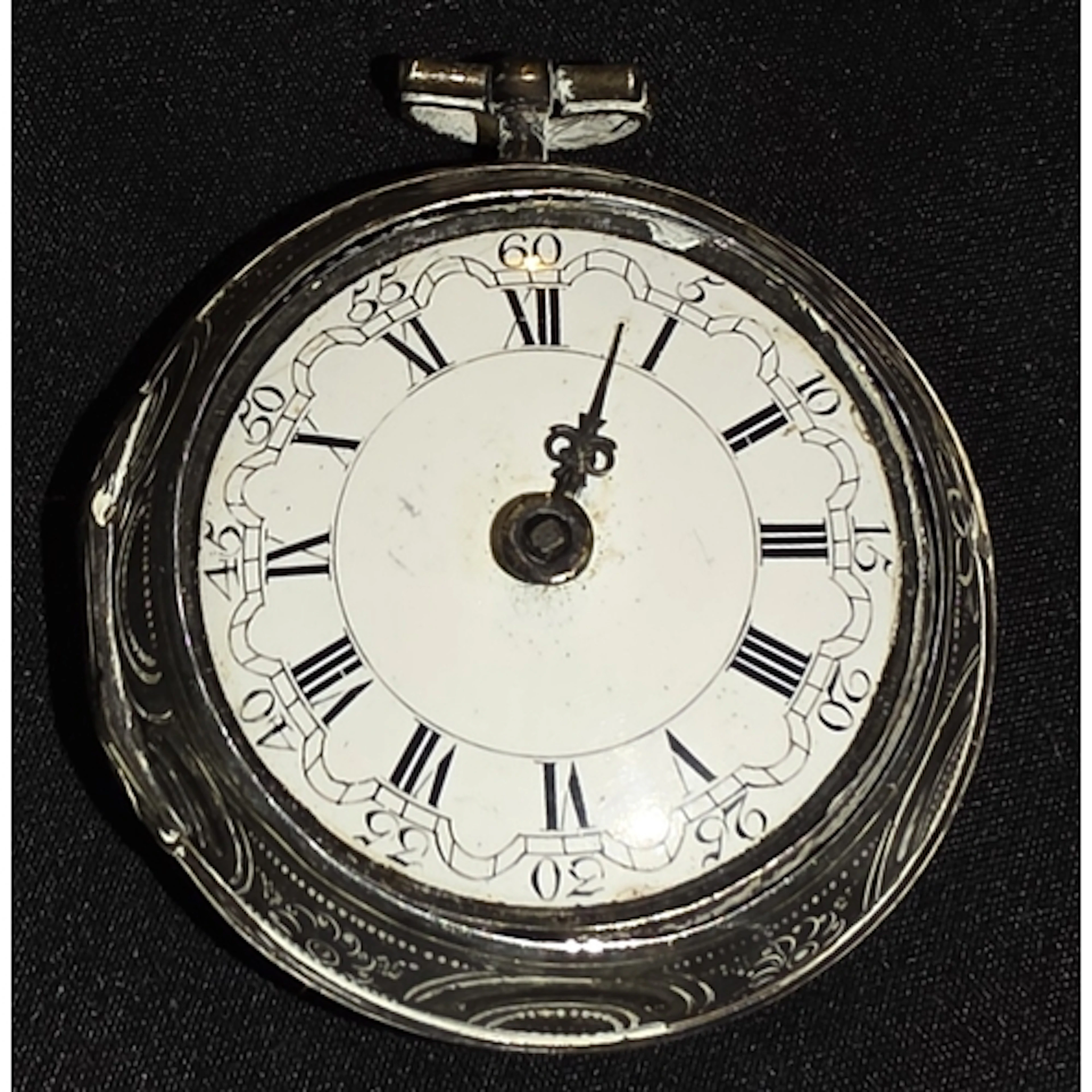 A 19th century pocket watch with embossed white metal case