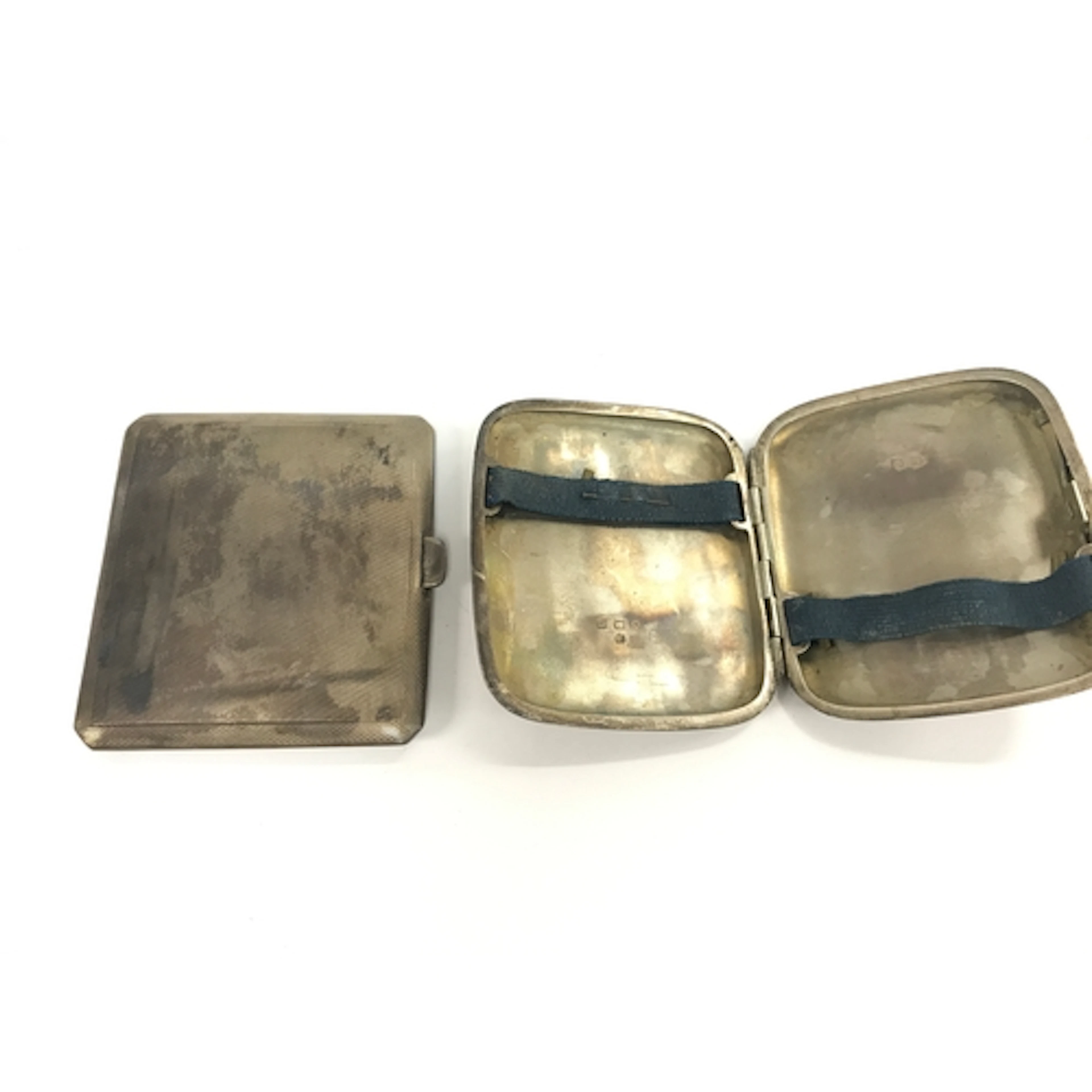 Two silver cigarette cases.