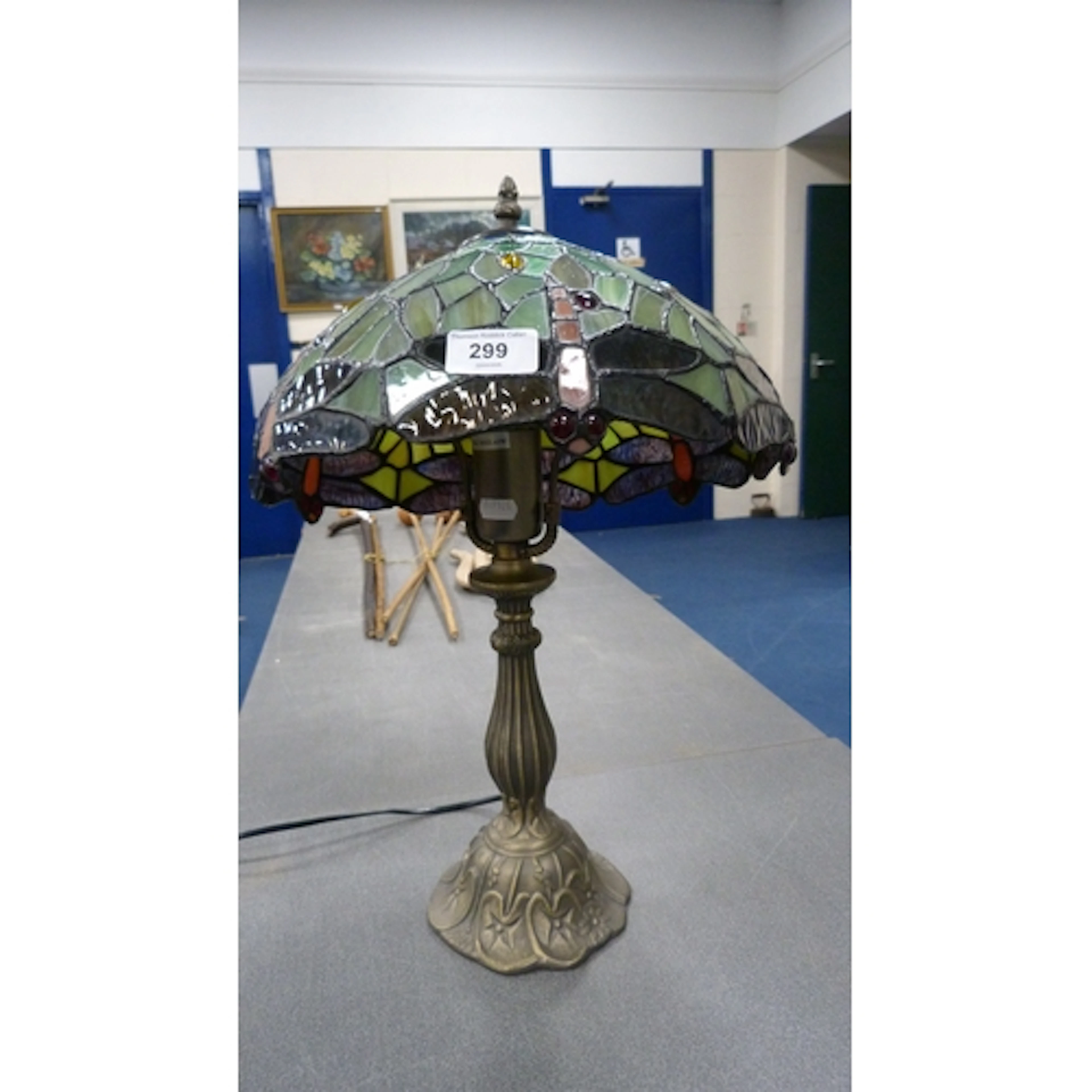 A Tiffany style table lamp with stained glass shade decorate...