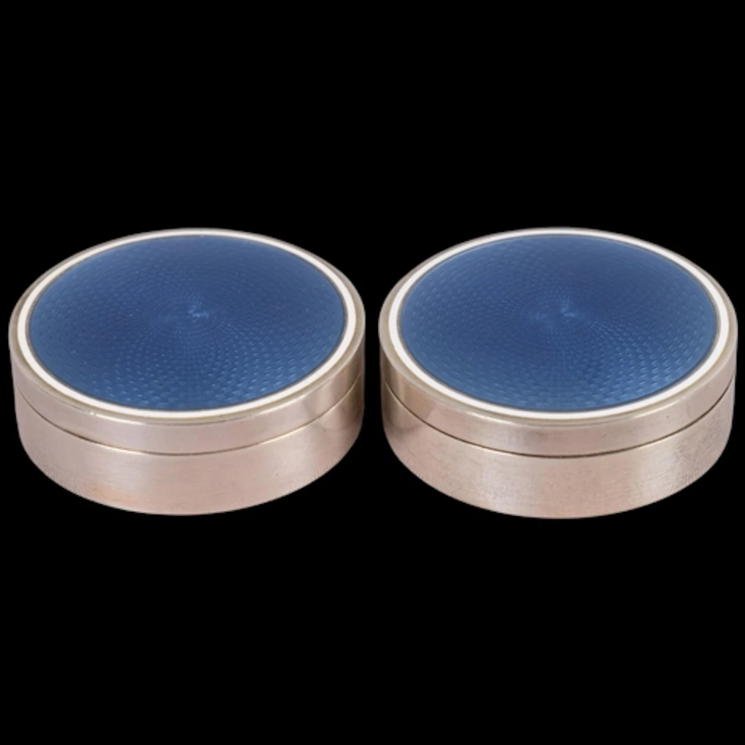 A pair of Art Deco French silver and enamel boxes, cylindric...