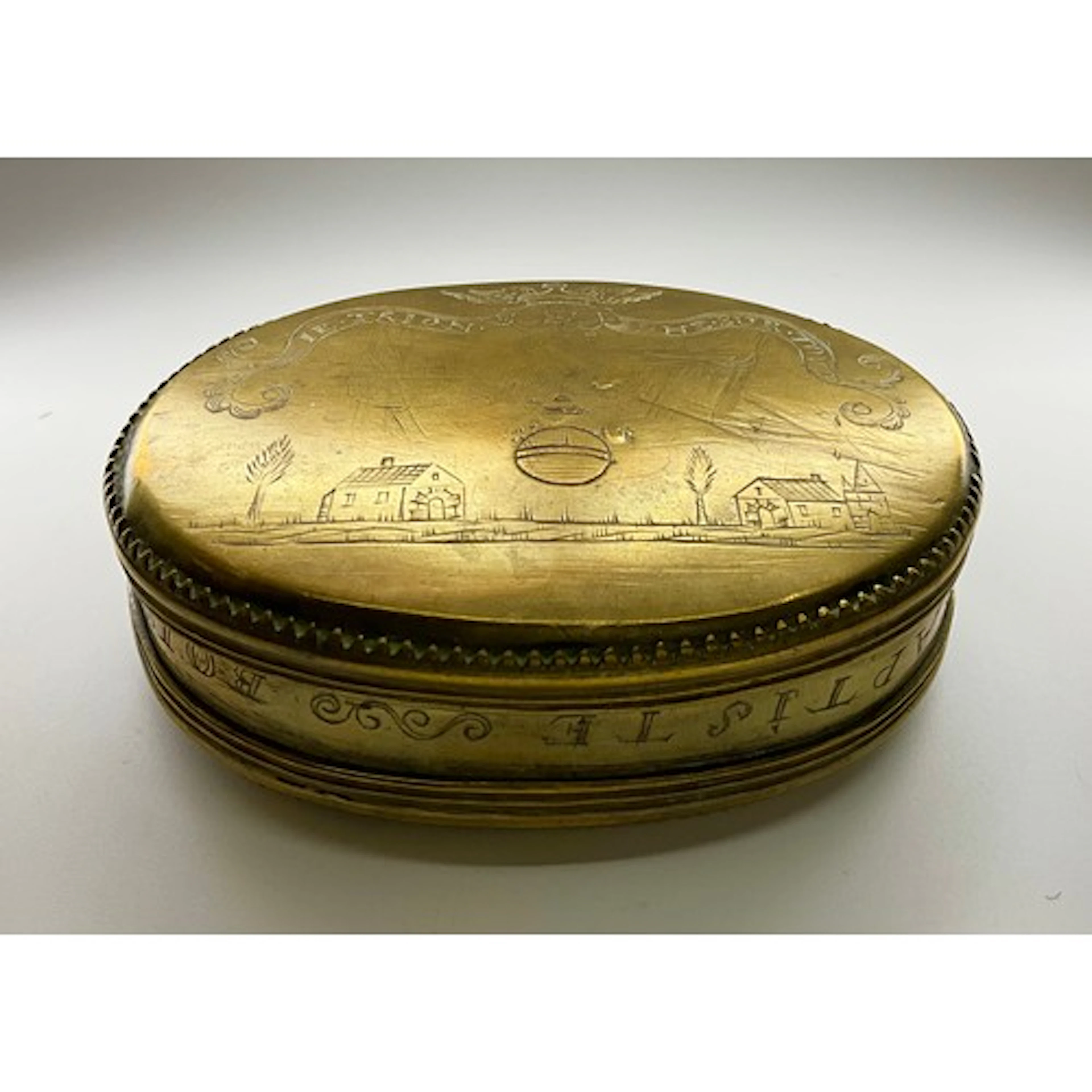 An early 18th century French brass oval tobacco box, hinged ...