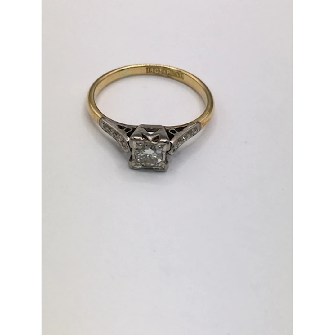 An 18ct gold ring having square cut mount set with diamond, ...