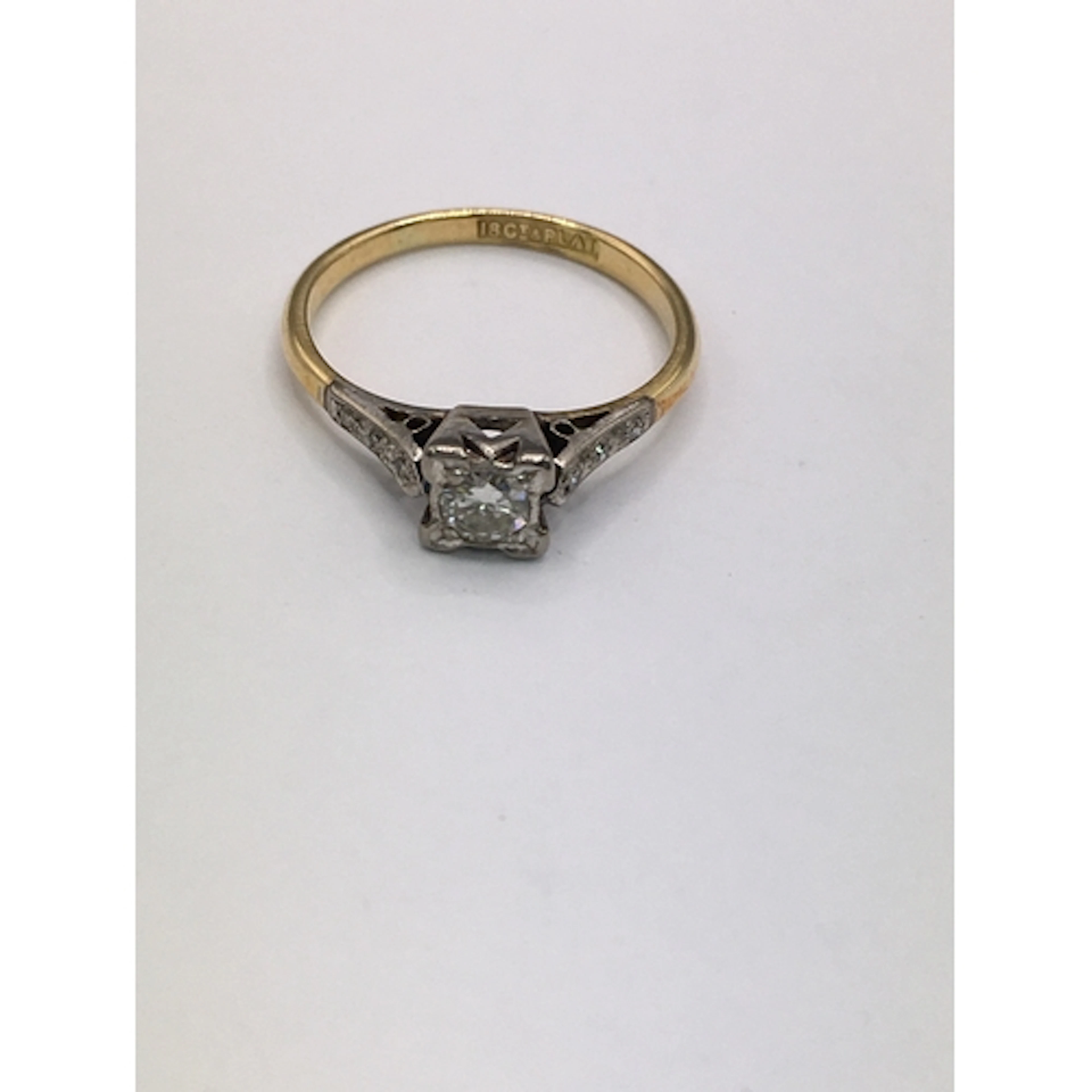 An 18ct gold ring having square cut mount set with diamond, ...