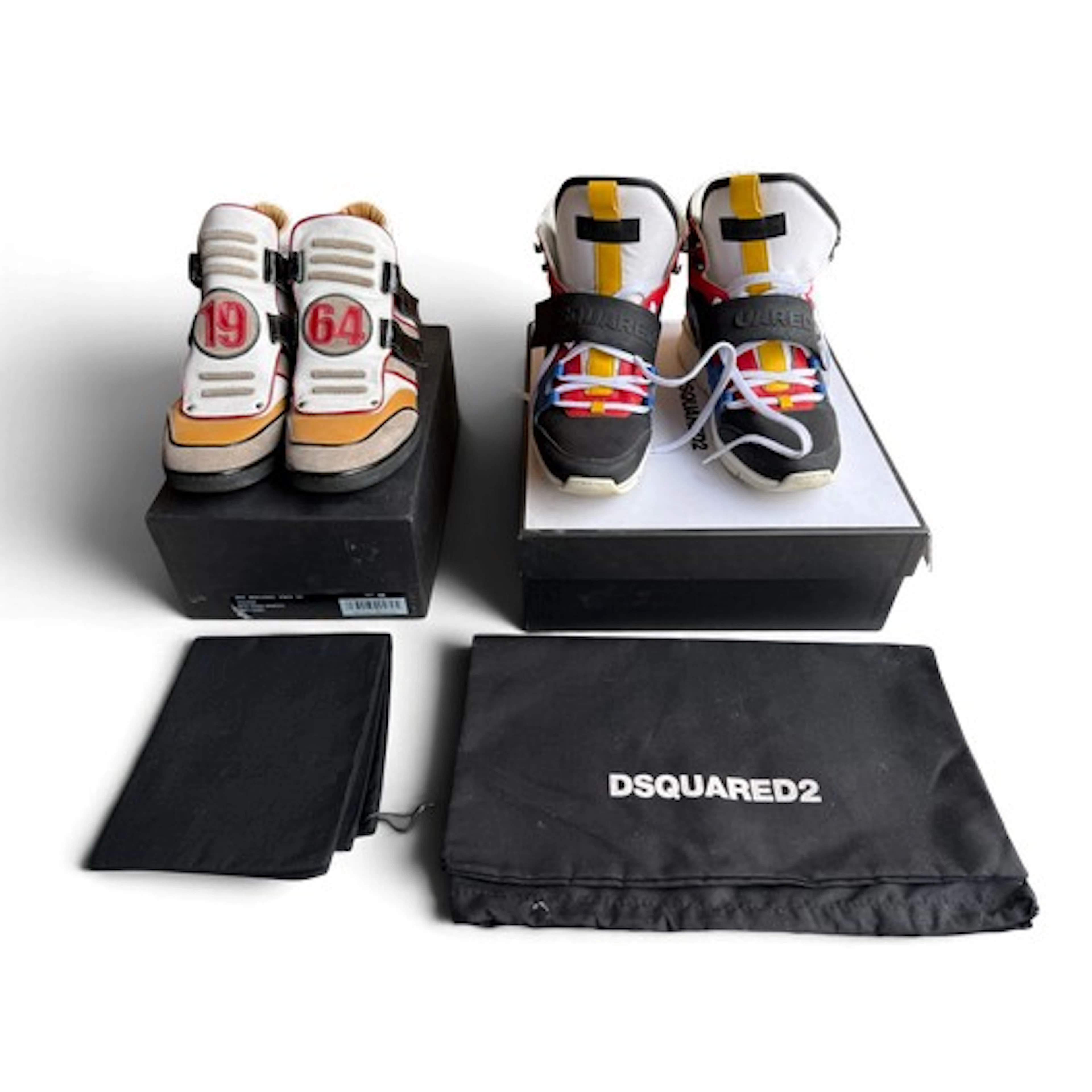 Two pairs of Dsquared2 high top trainers with boxes and dust...