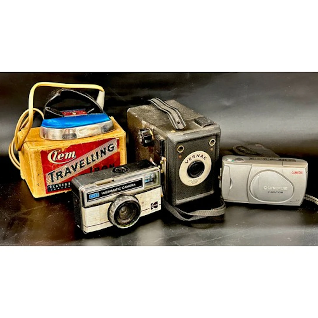Three cameras, Olympus, Kodak and Vernak, together with a tr...