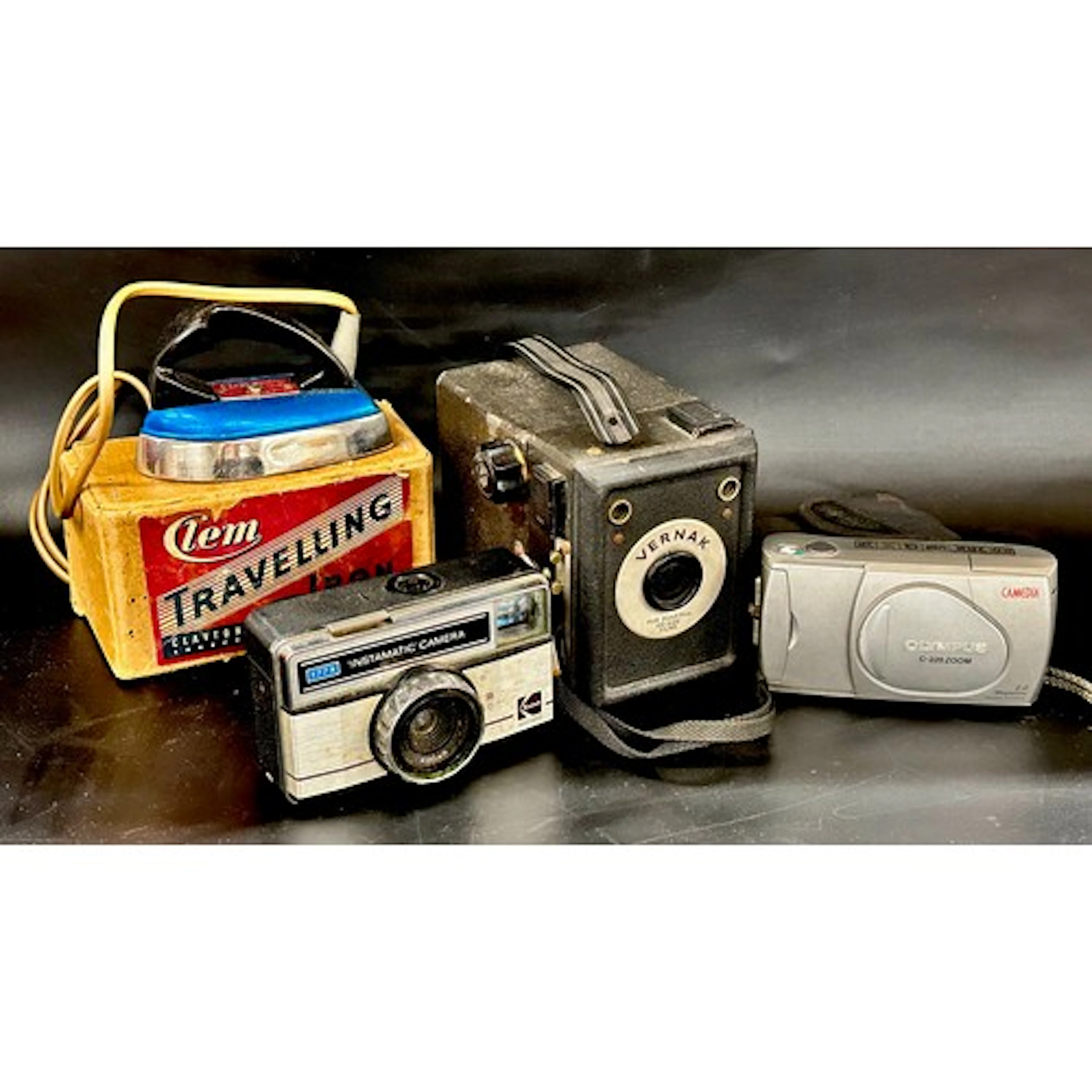 Three cameras, Olympus, Kodak and Vernak, together with a tr...