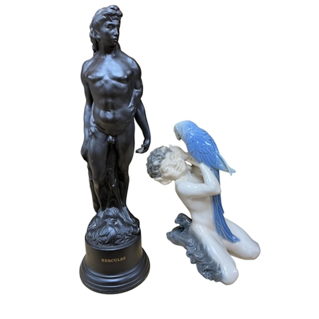 A Royal Copenhagen figure of a faun and parrot (no. 752), he...
