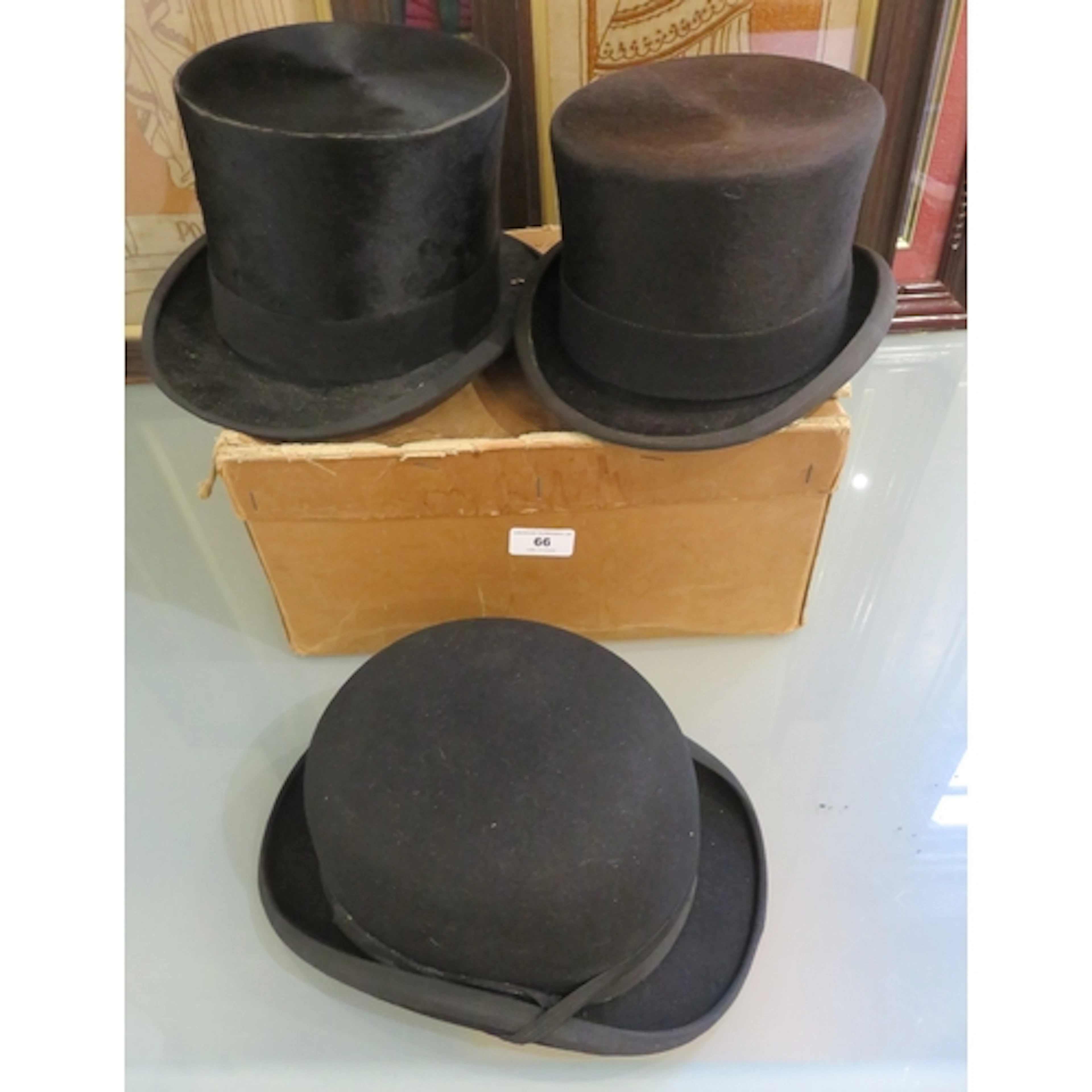 Two silk top hats, together with a bowler hat