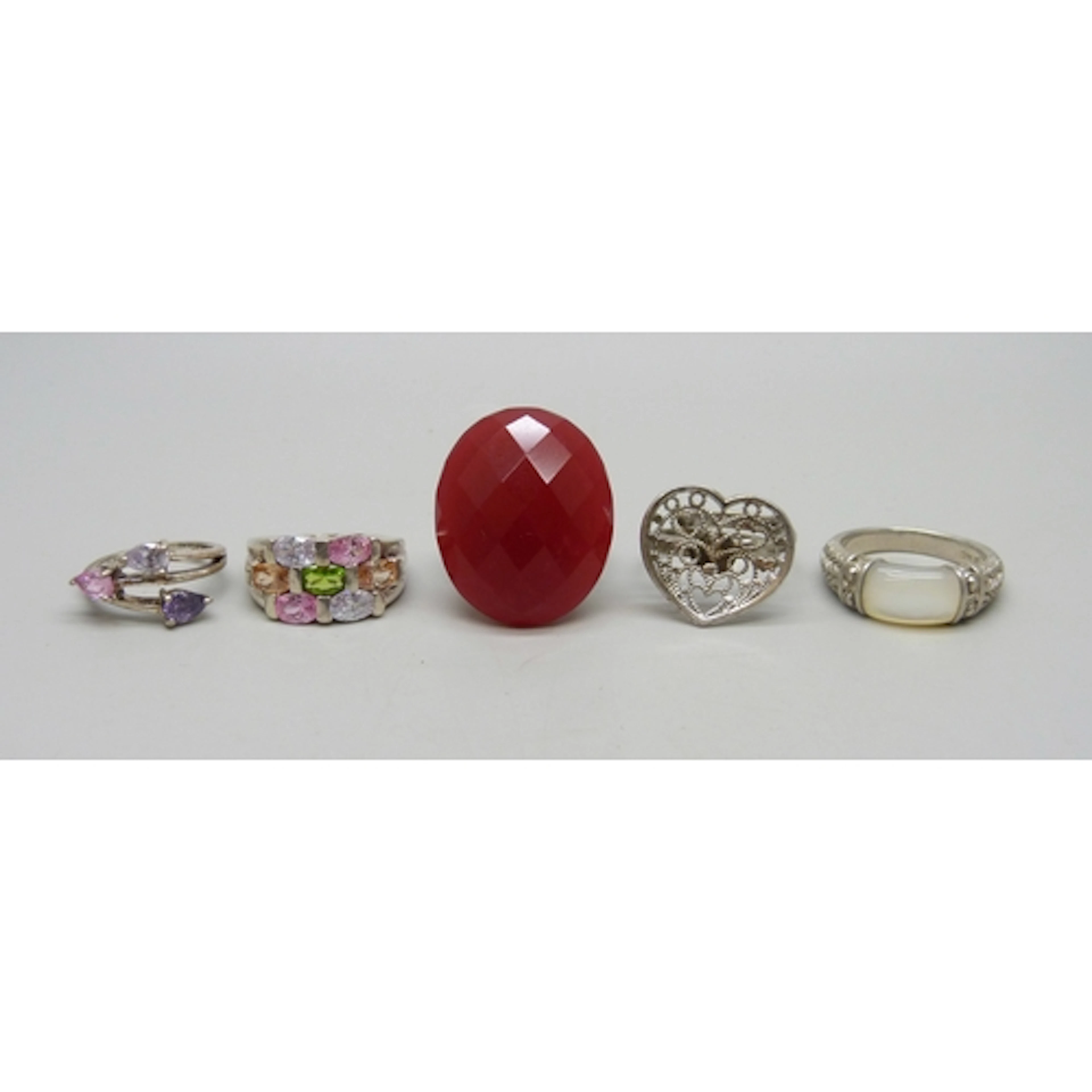 Five silver and white metal rings including Whitney Kelly, 3...