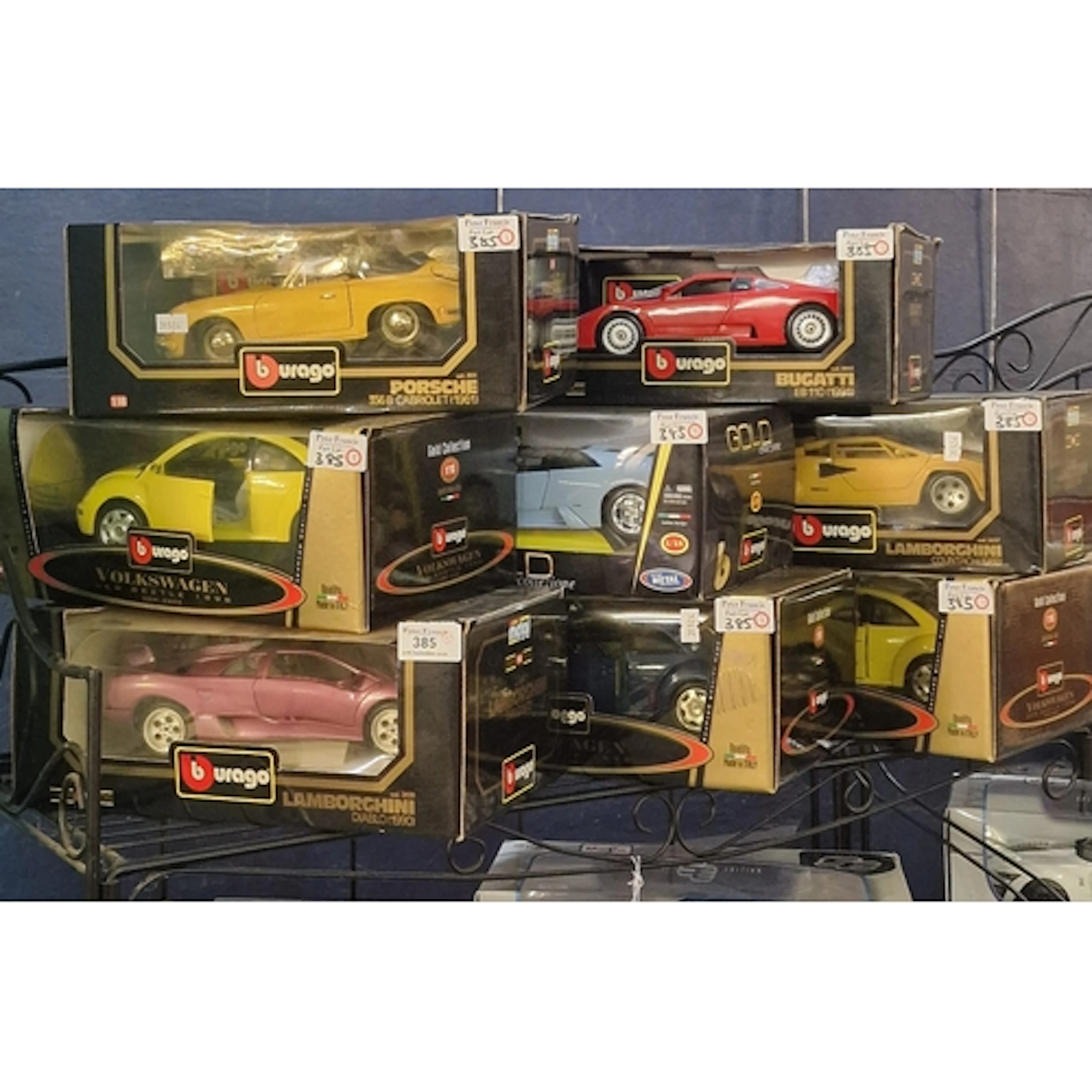 Eight Burago 1:18 scale model vehicles all in original boxes...