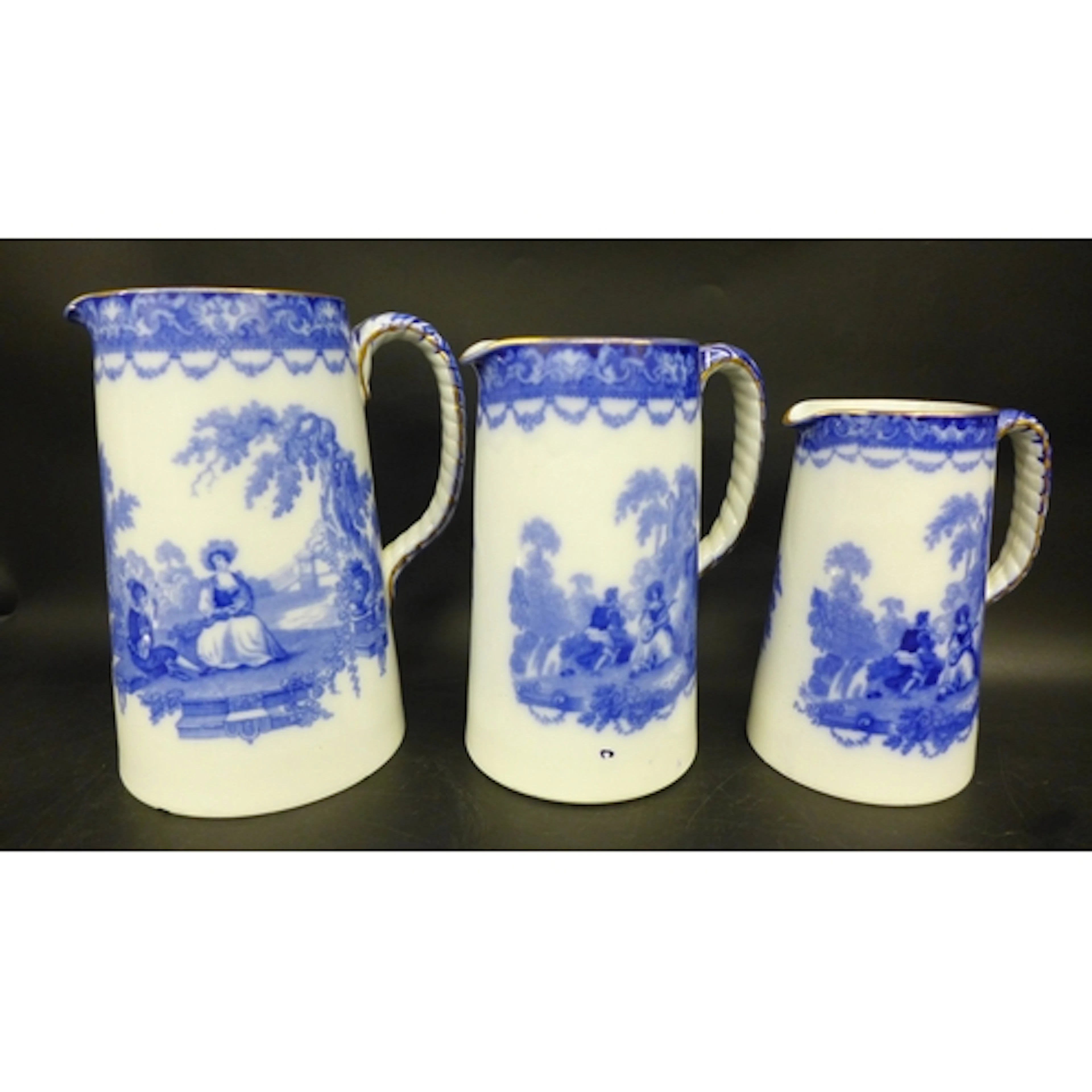 Three Doulton Burslem graduating jugs in pattern 'Watteau', ...