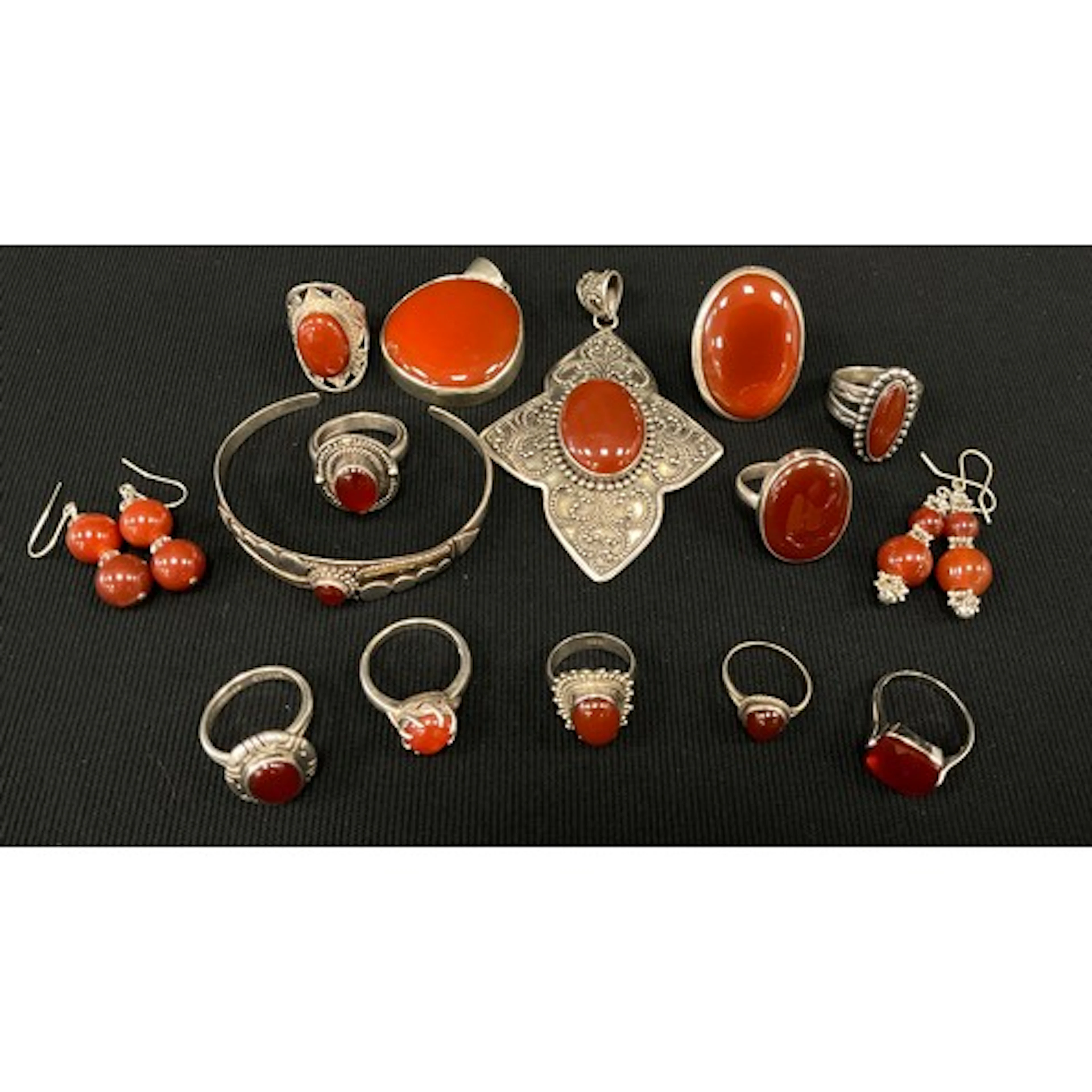 A deep red carnelian silver mounted pendant, another, bangle...