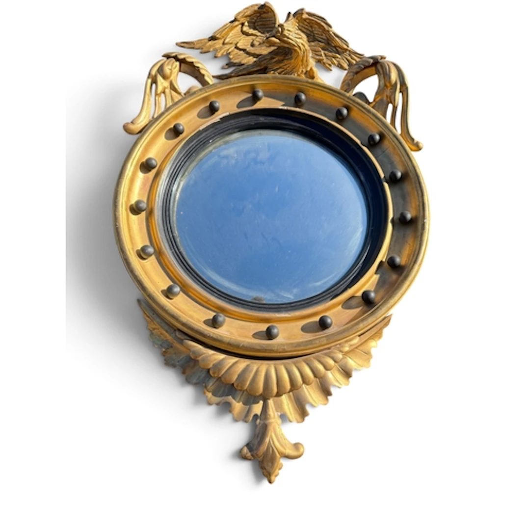 A REGENCY STYLE GILTWOOD, GESSO AND EBONISED FRAME CONVEX WA...