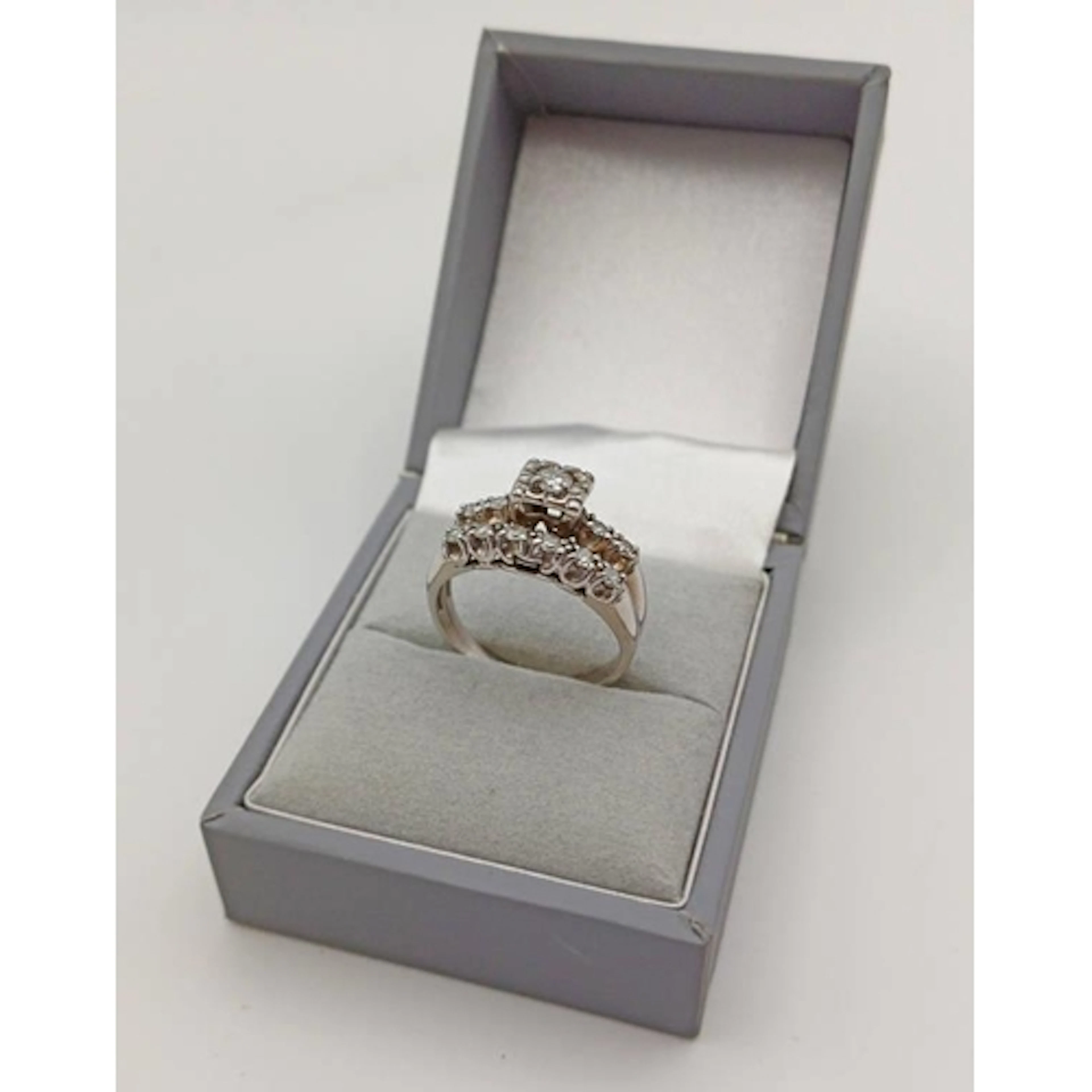 GOLD DIAMOND SET RING WITH A SINGLE STONE IN RAISED FLANKED ...