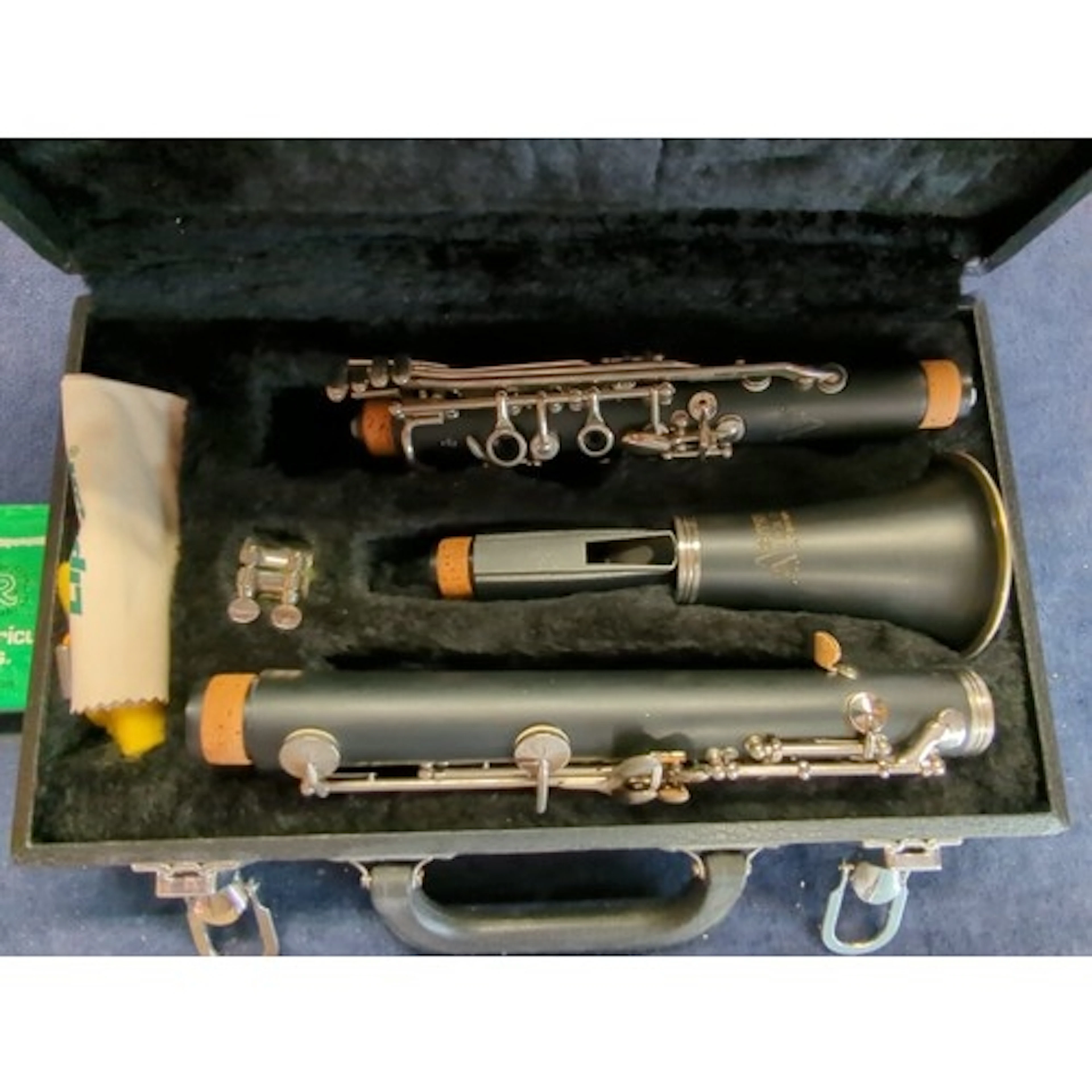 Cased black resin clarinet, assembled with silvered keys and...