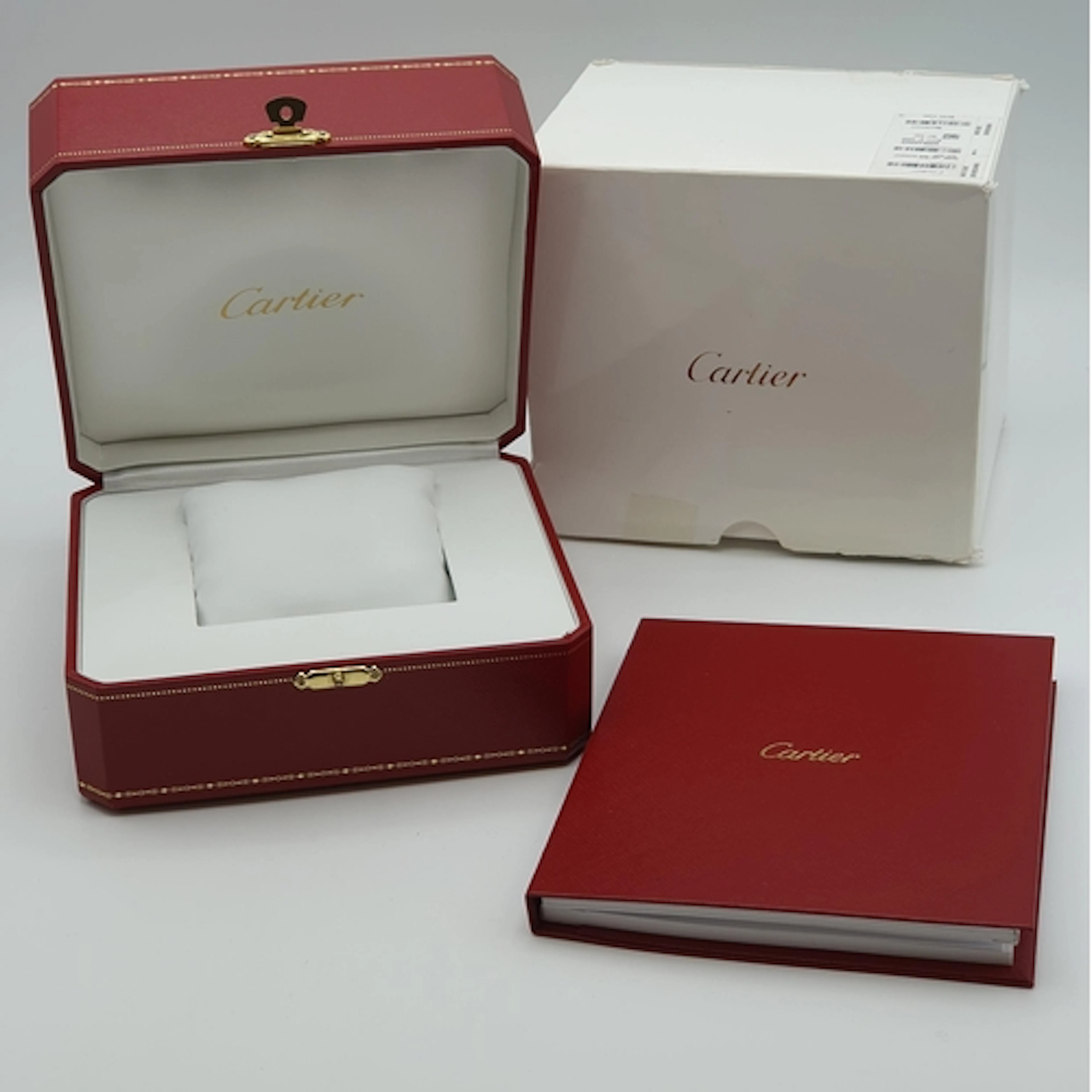 A red leather-effect Cartier Watch Box with instruction and ...
