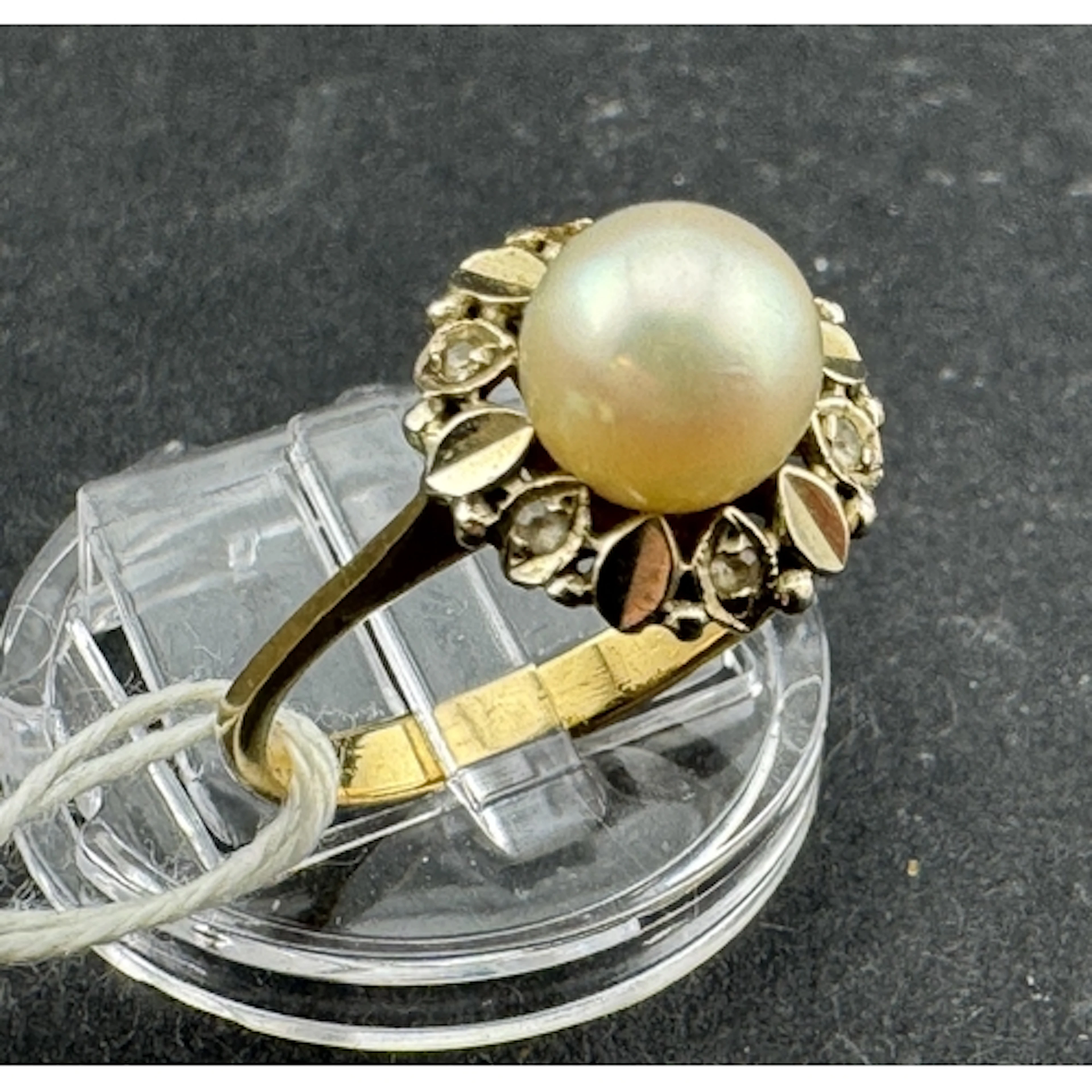 Jewellery: Yellow metal ring set with a 6.5mm cultured pearl...