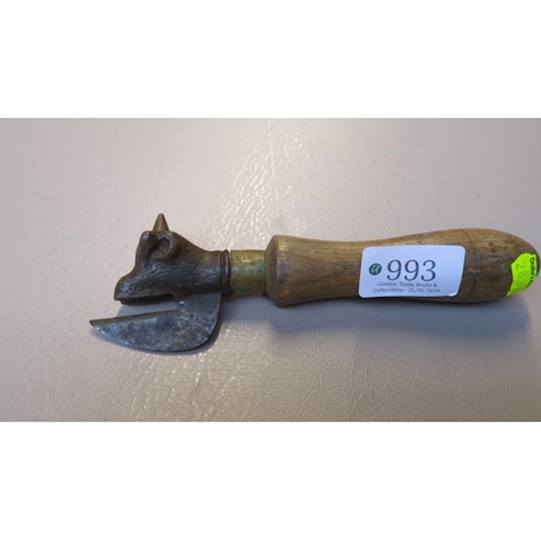 Bull’s-head tin opener with a cast-iron head, curved cutting...