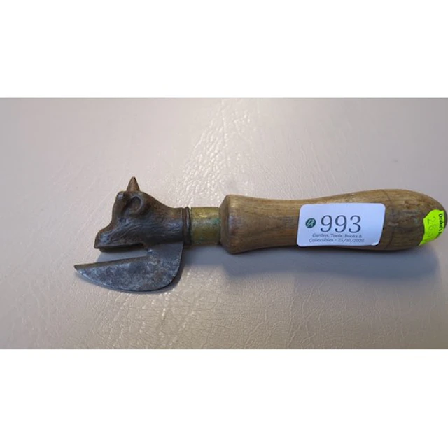Bull’s-head tin opener with a cast-iron head, curved cutting...