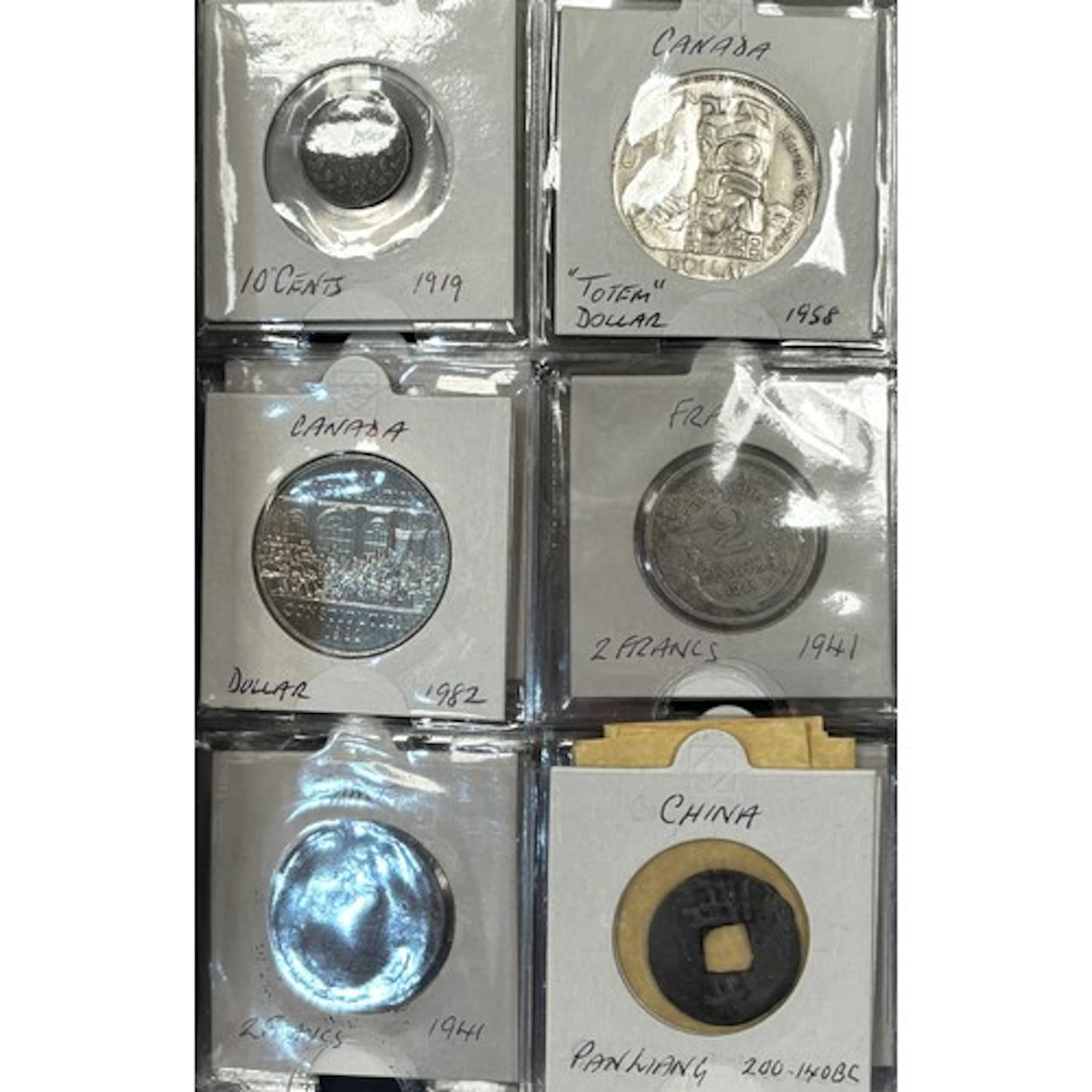 2 albums of world coins including 1986 1oz silver eagle, 192...