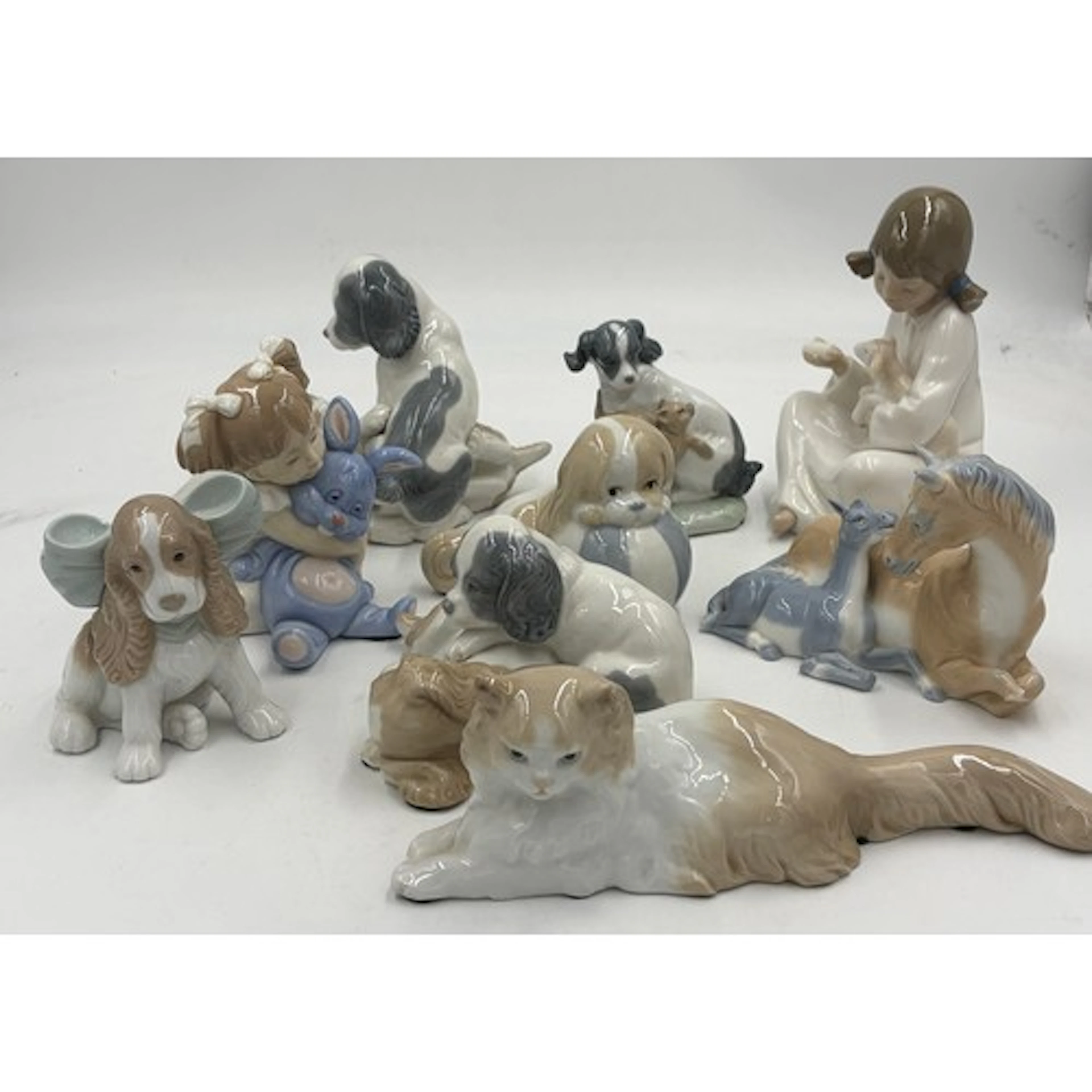 Collection of Nao figures to include dogs, cats, children to...