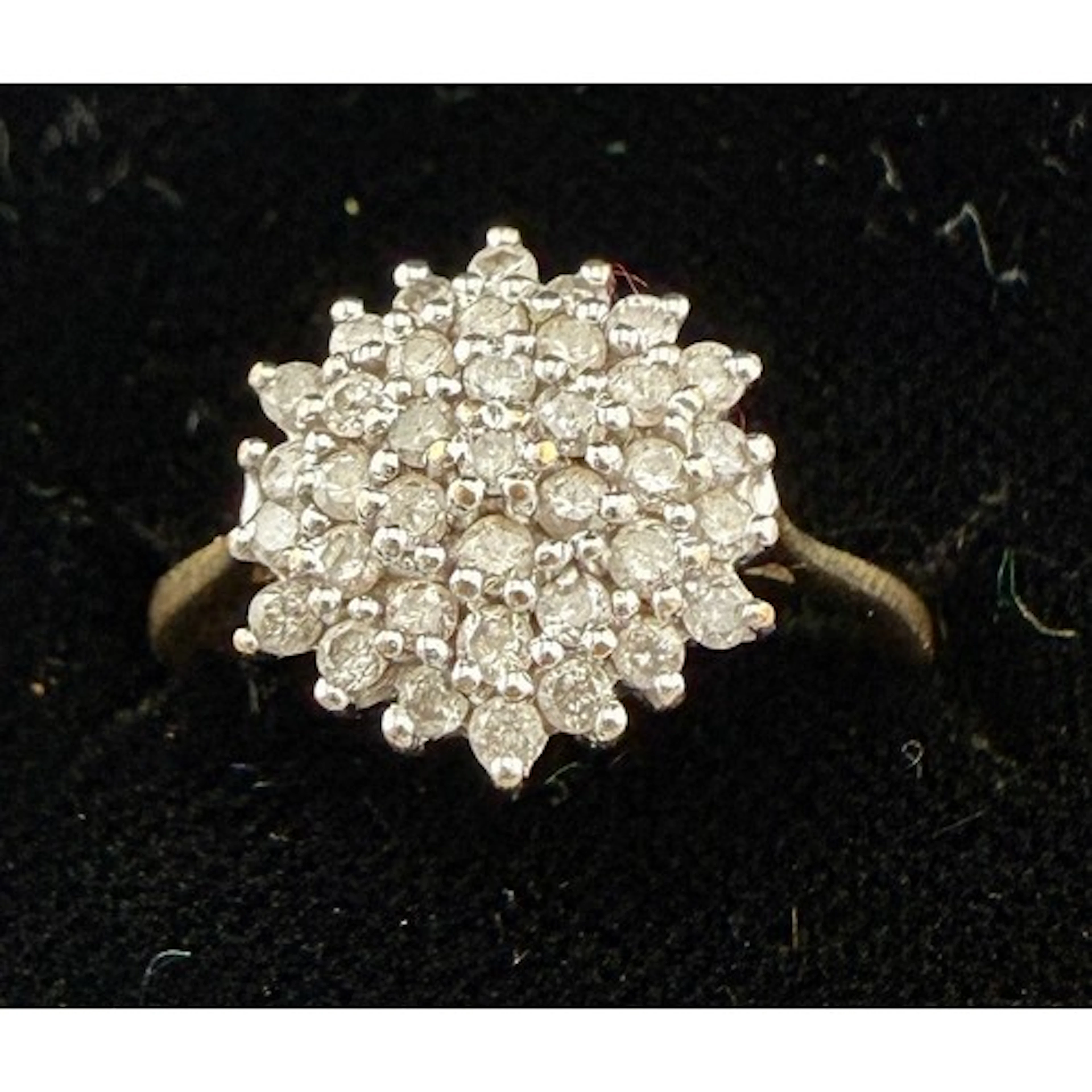A 9 carat gold cluster ring set with clear stones. Size L. W...