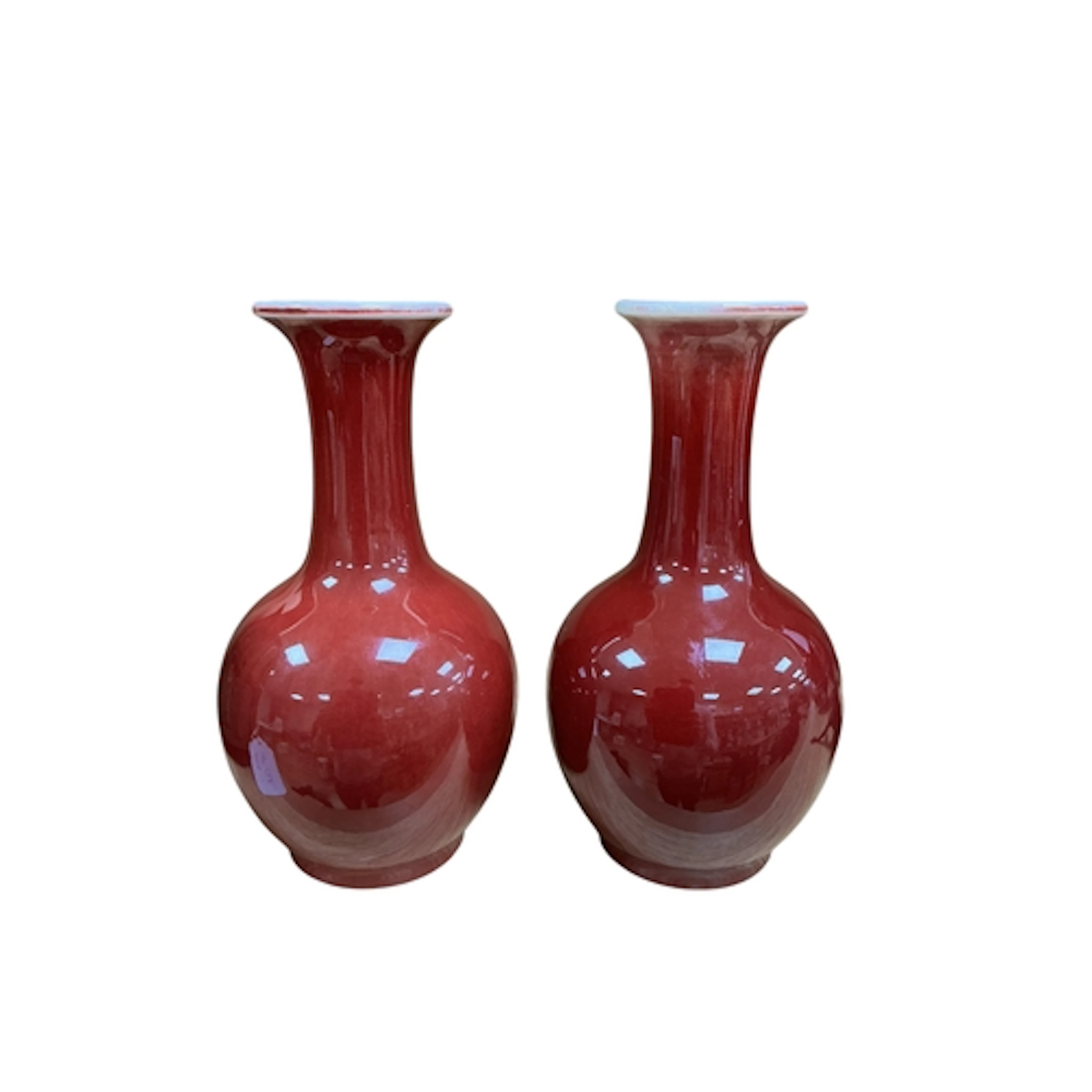 A near pair of Chinese sang de boeuf glazed bottle vases, 19...
