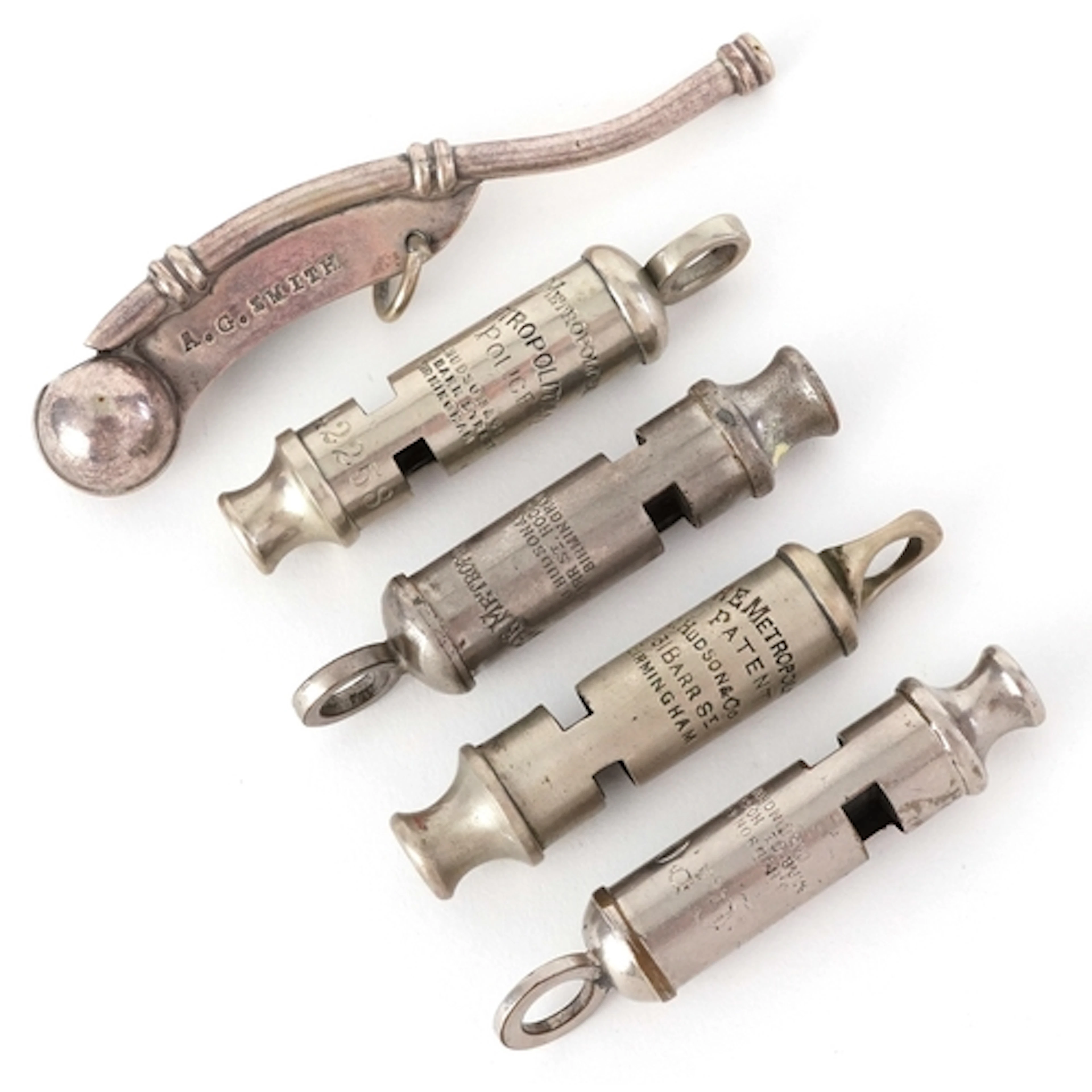 Five vintage whistles comprising a bosun's whistle, three J ...