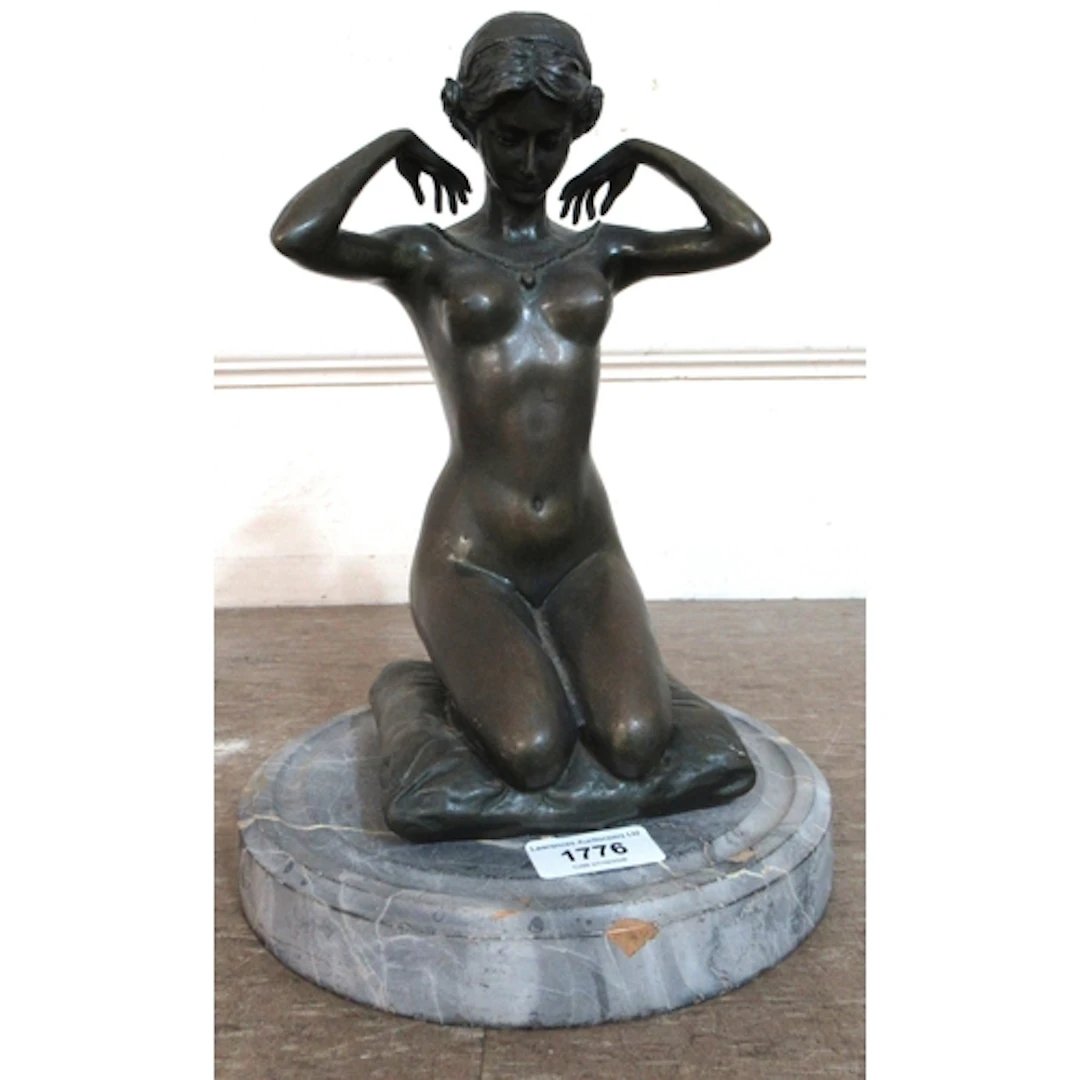 Dark patinated bronze figure of a kneeling nude on a circula...