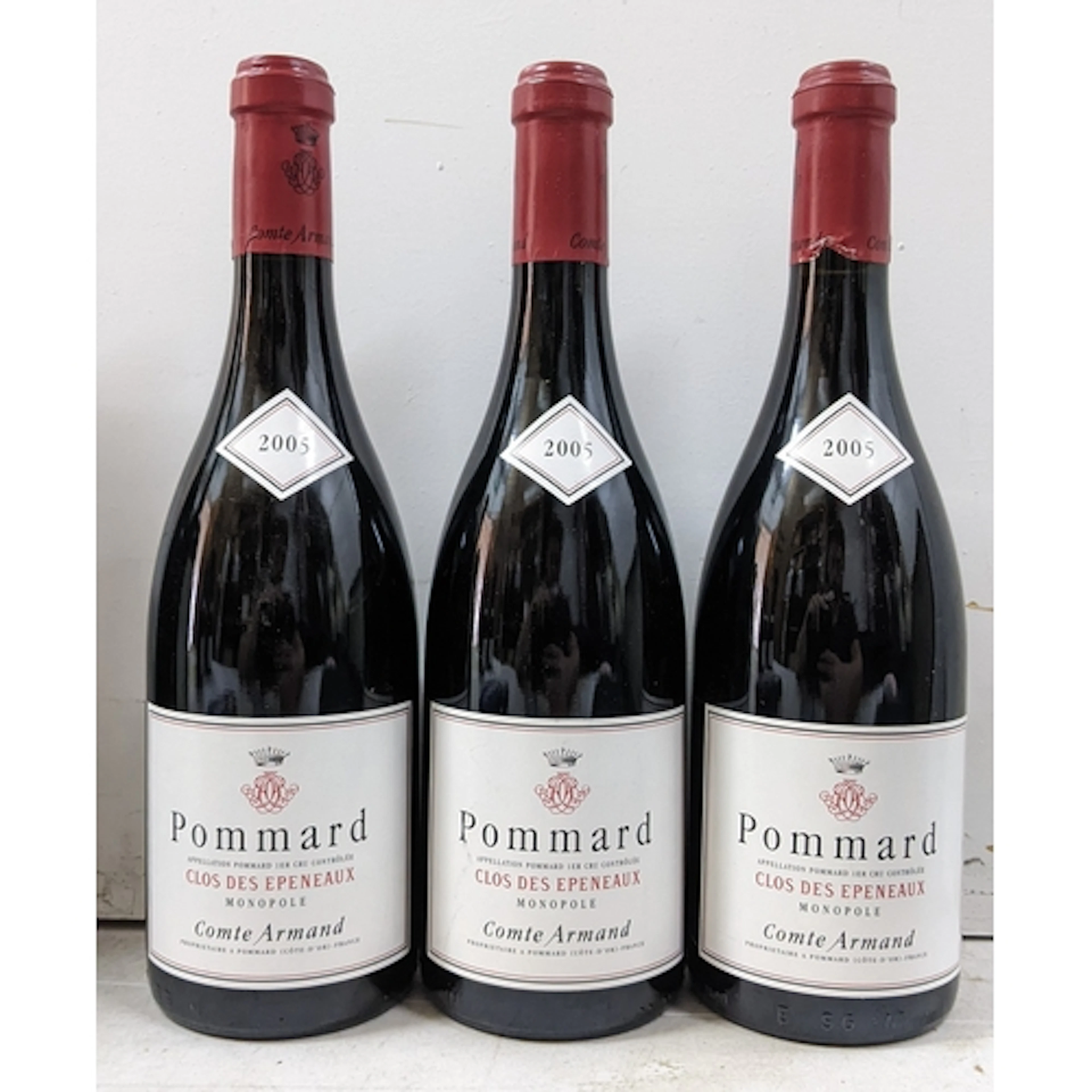 A group of three bottles of Pommard 1er Cru “Clos des Epenea...