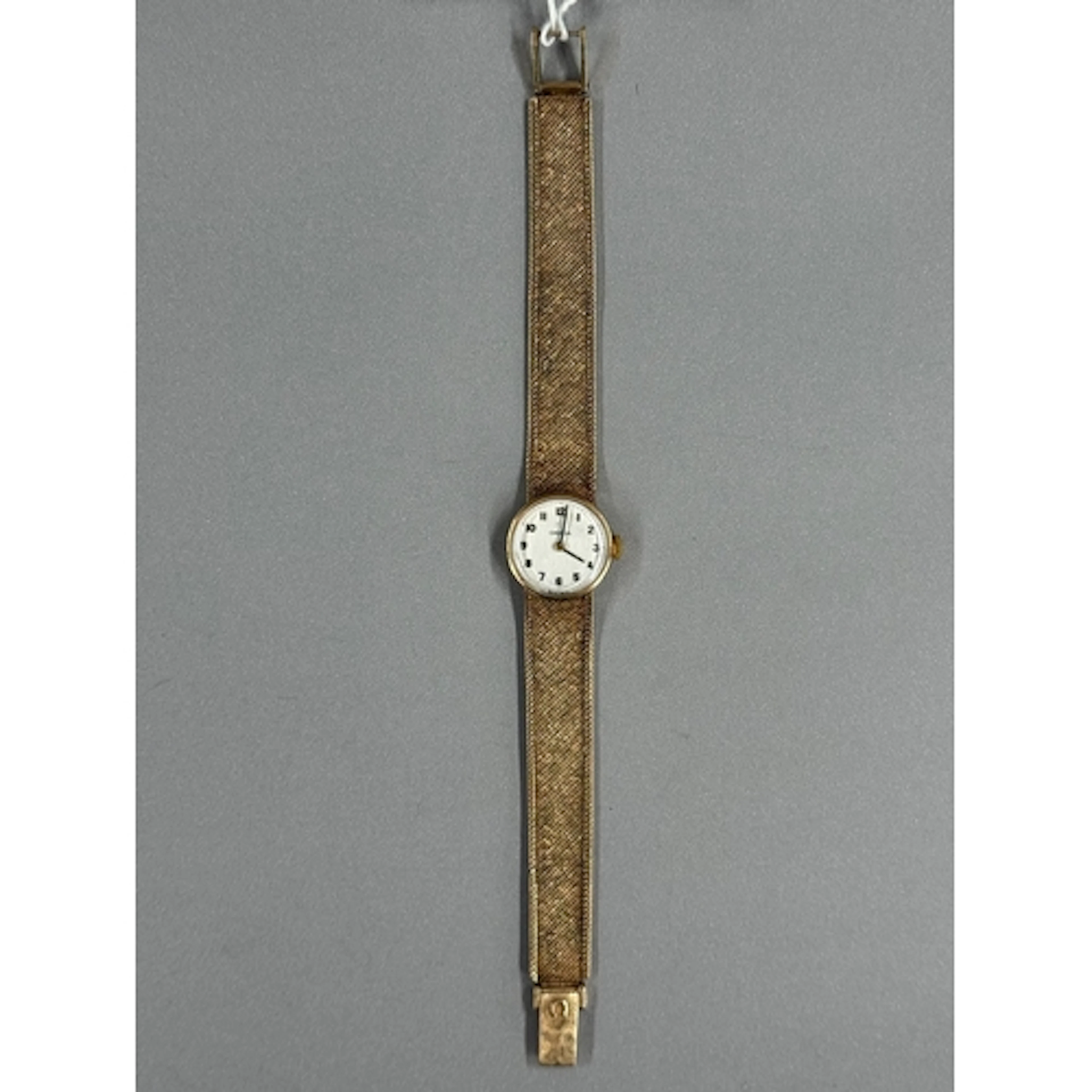 Watches: a ladies 9ct gold Omega wristwatch on integral mesh...