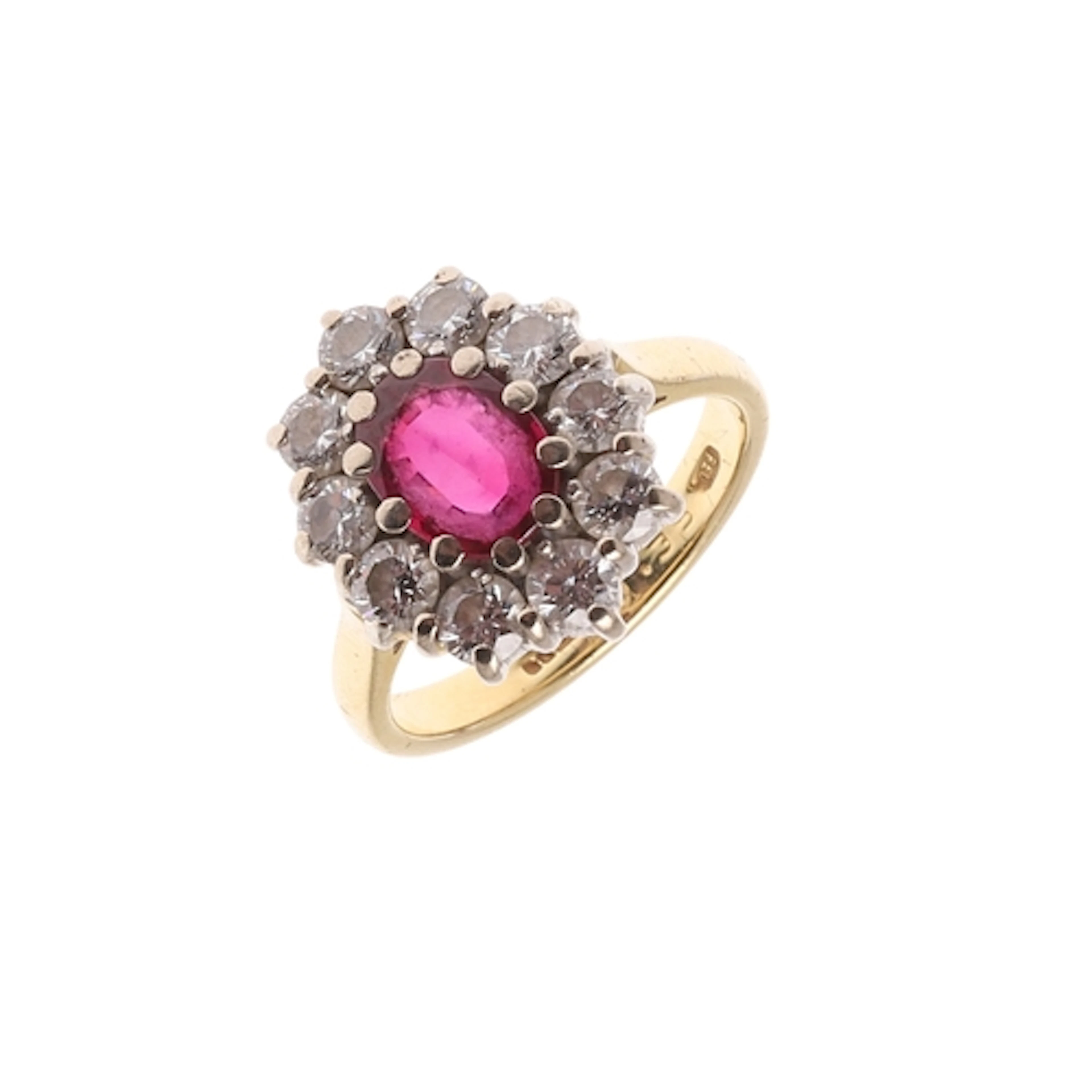 A RUBY AND DIAMOND CLUSTER RING. the oval-shaped ruby is set...
