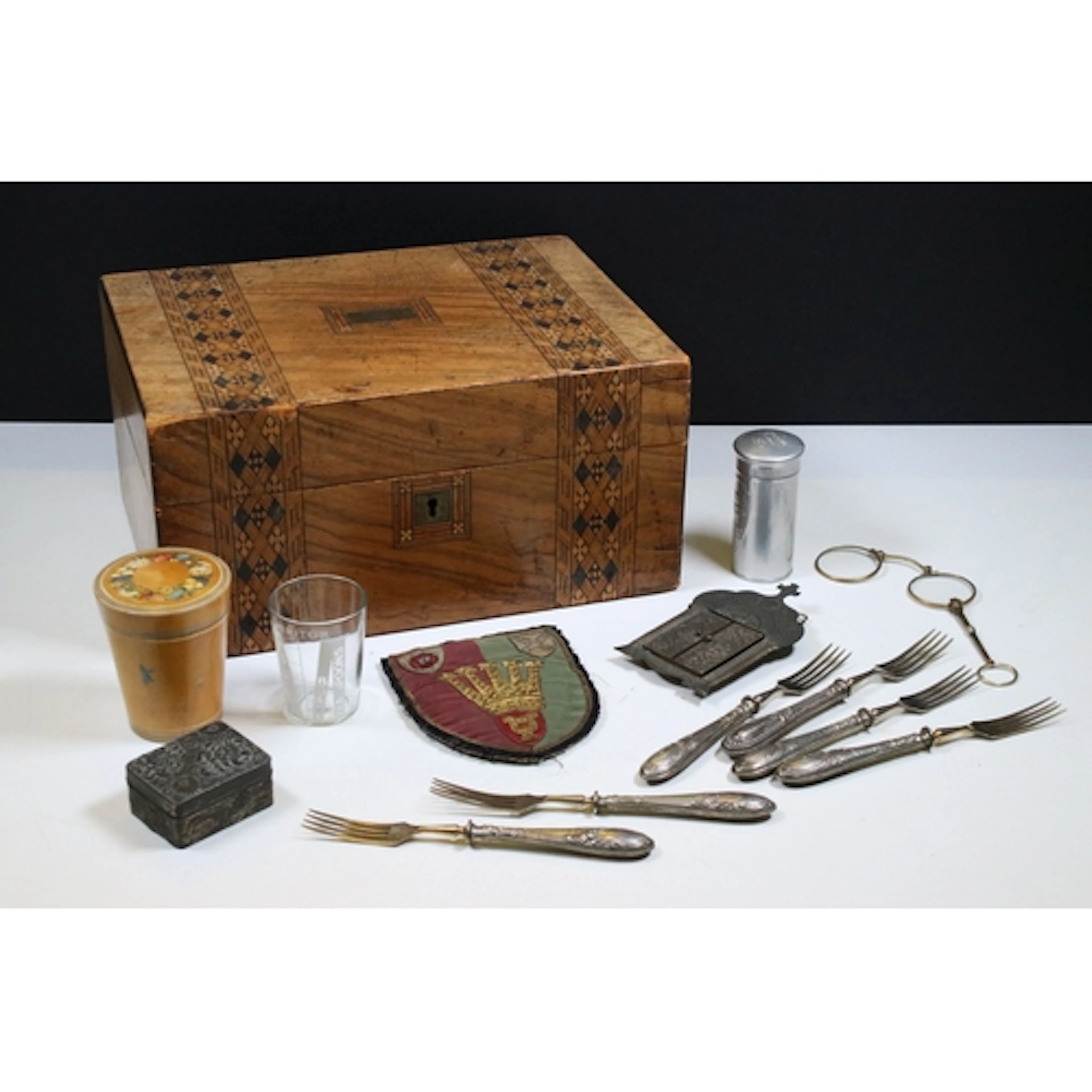 A small group of mixed collectables within a vintage wooden ...