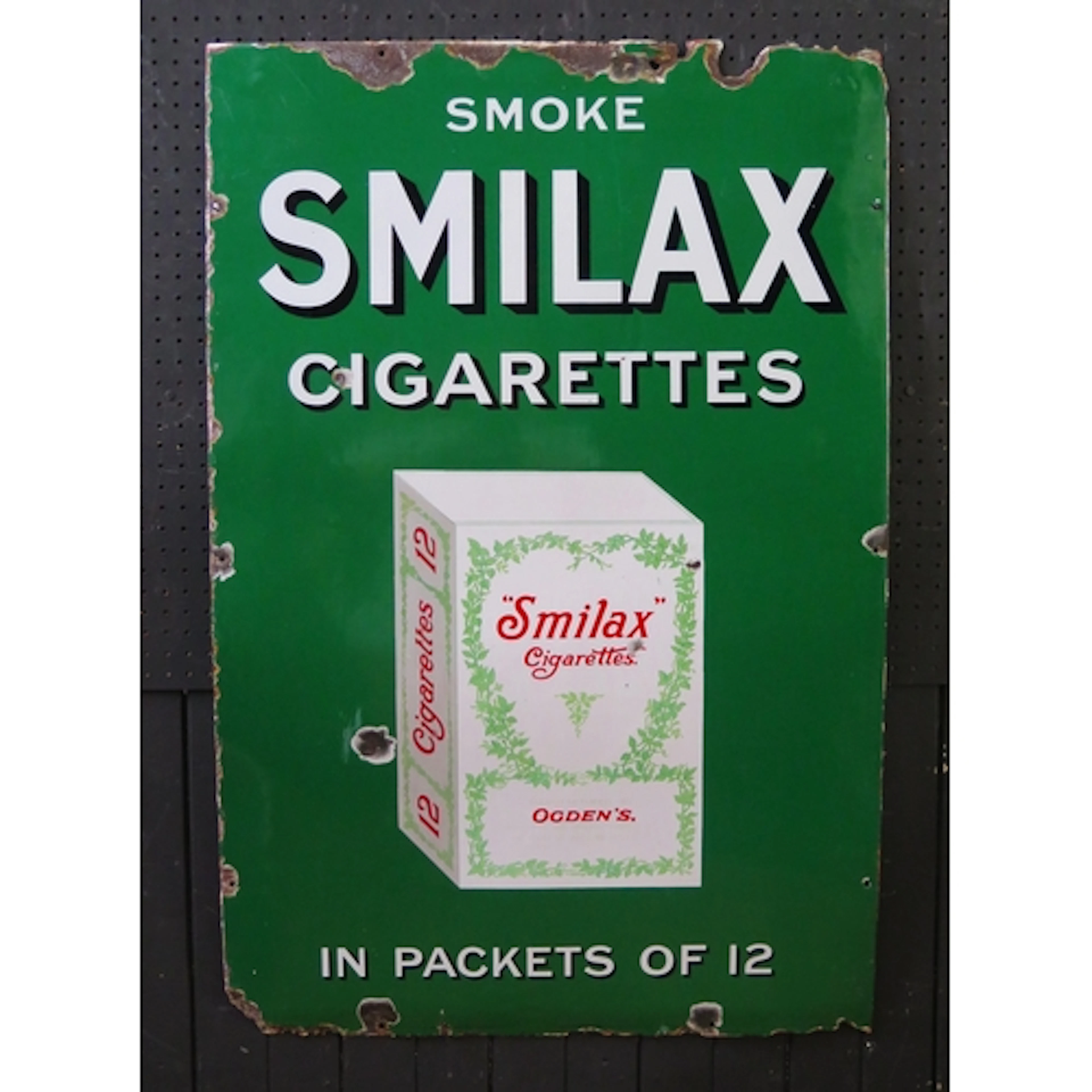 "Smoke Smilax Cigarettes in Packets Of 12" - an enamel adver...