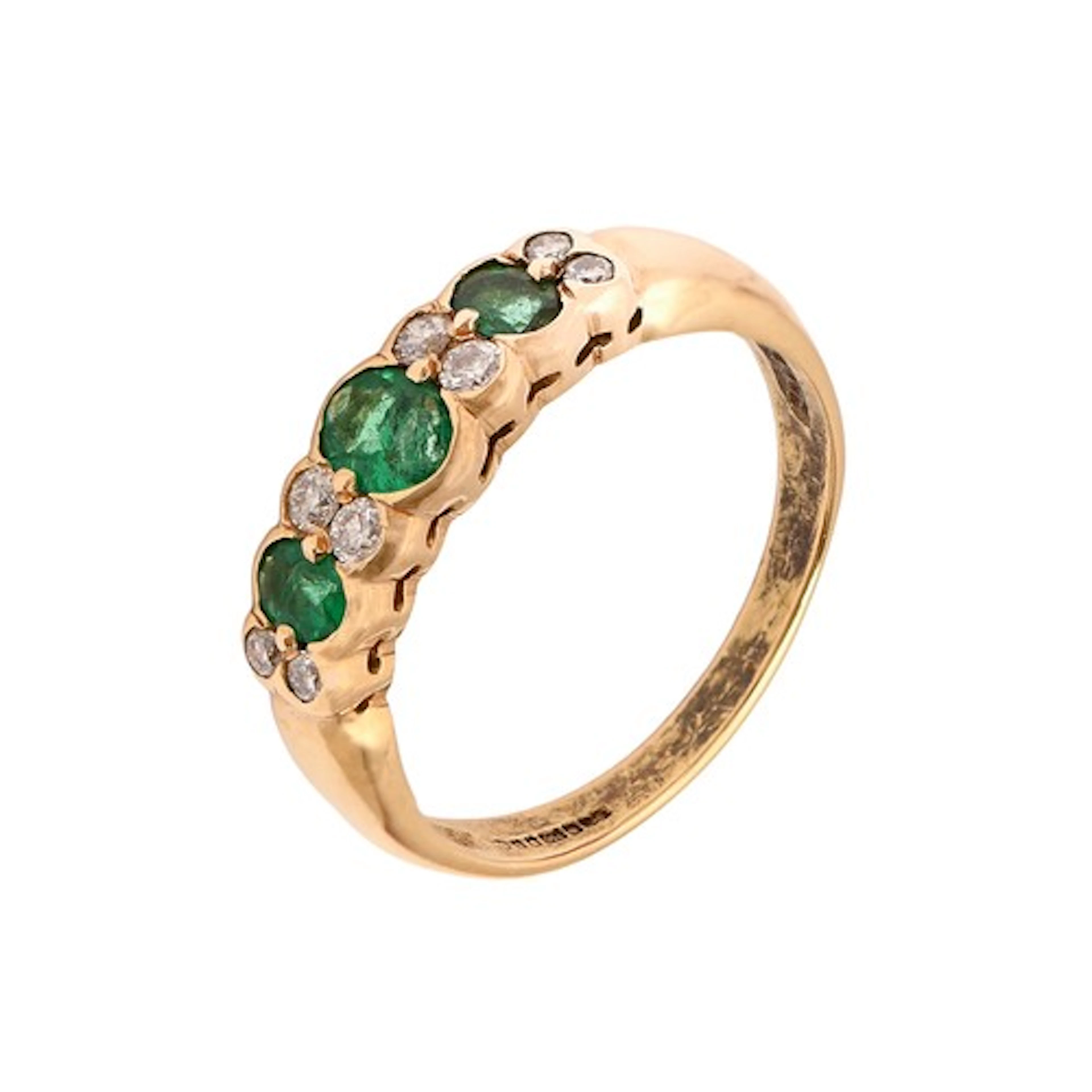 An emerald and diamond ring, the three larger emeralds divid...