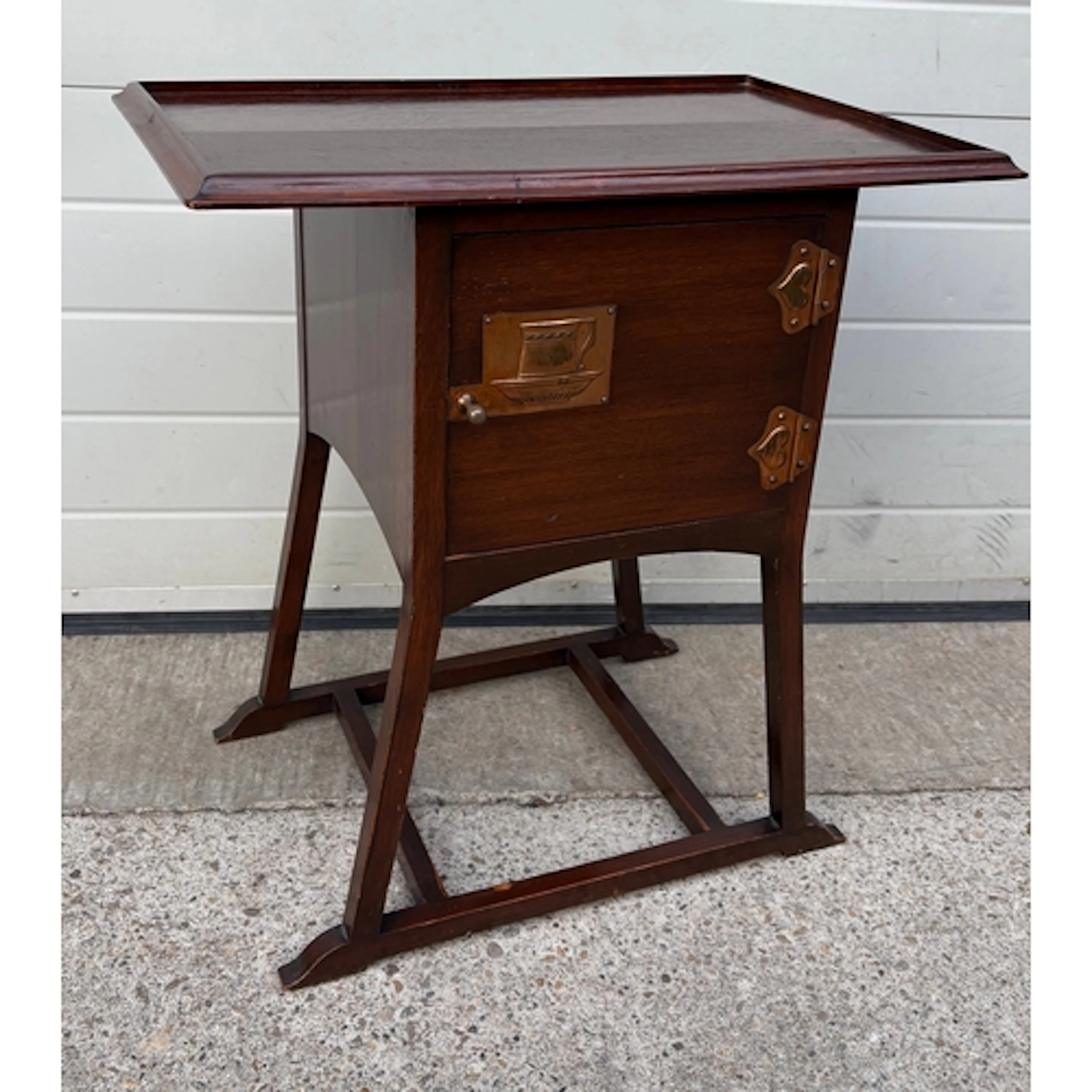An Arts & Crafts mahogany bedside and tea tray table, in the...