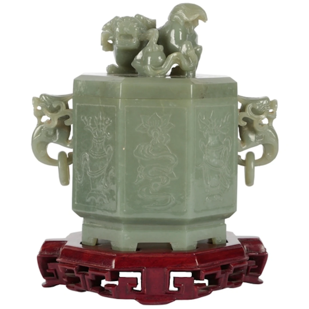 A large Chinese green jade 'auspicious objects' octagonal bo...